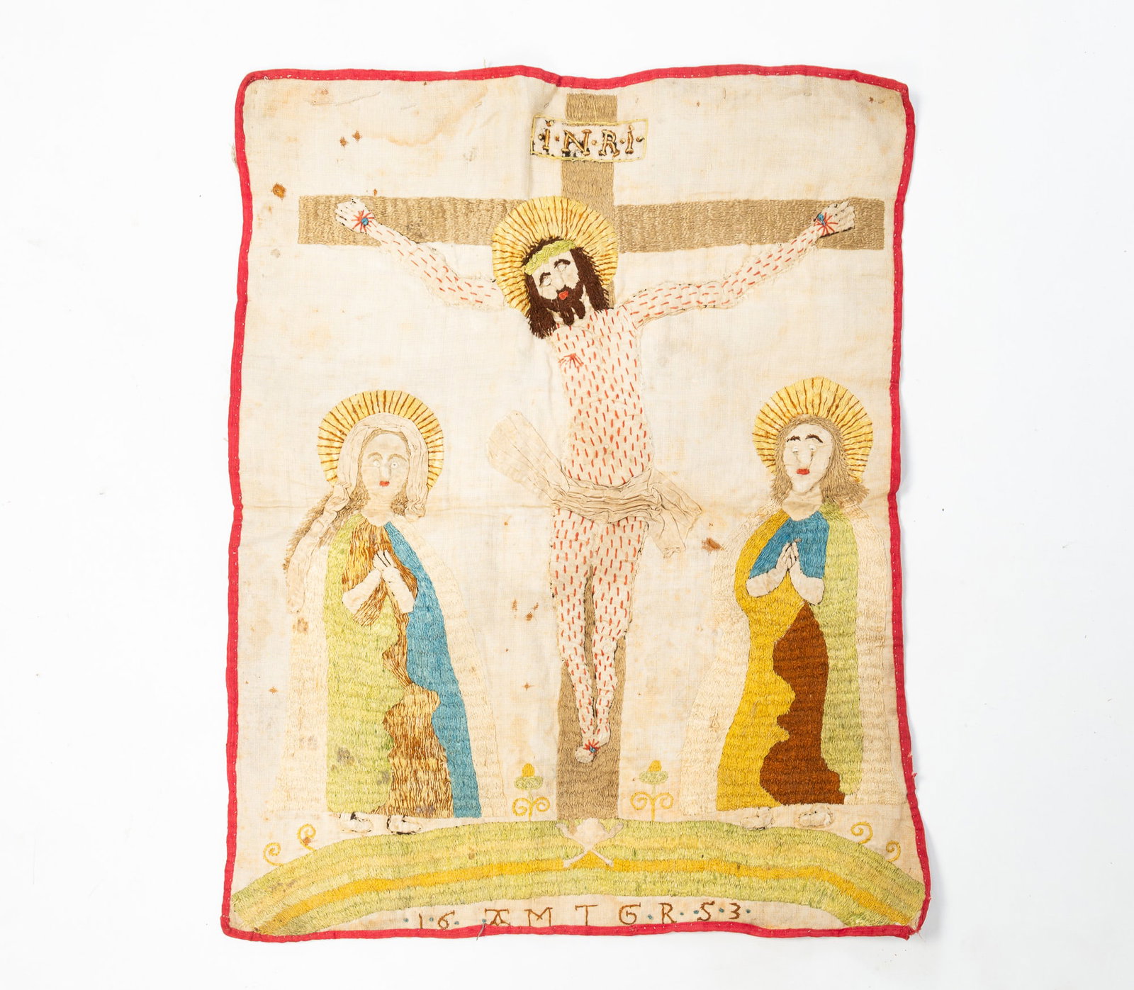 FOLK ART NEEDLEWORK AND STUFFED WORK SCENE OF THE CRUCIFIXION.: FOLK ART NEEDLEWORK AND STUFFED WORK SCENE OF THE CRUCIFIXION. American, 19th Century. Polychrome thread on linen. Hand-sewn depiction of Jesus on the cross wearing a halo, crown, beard, and a cloth,