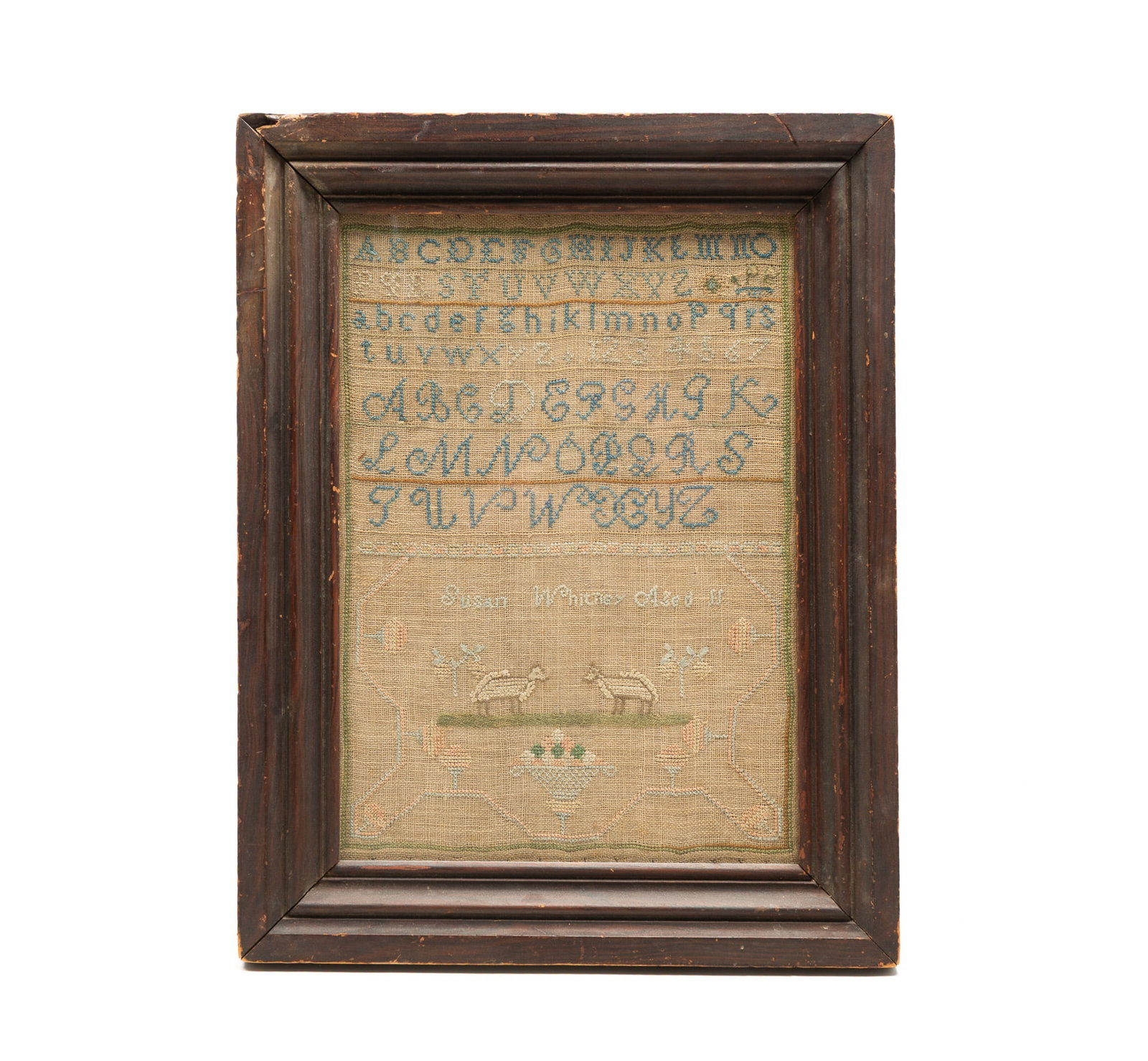 SUSAN WHITNEY NEEDLEWORK SAMPLER.: SUSAN WHITNEY NEEDLEWORK SAMPLER. American, 19th Century. Colored thread on linen. Rows of alphabets and numerals above a colorful line, two sheep grazing, and an urn filled with flowers all contained