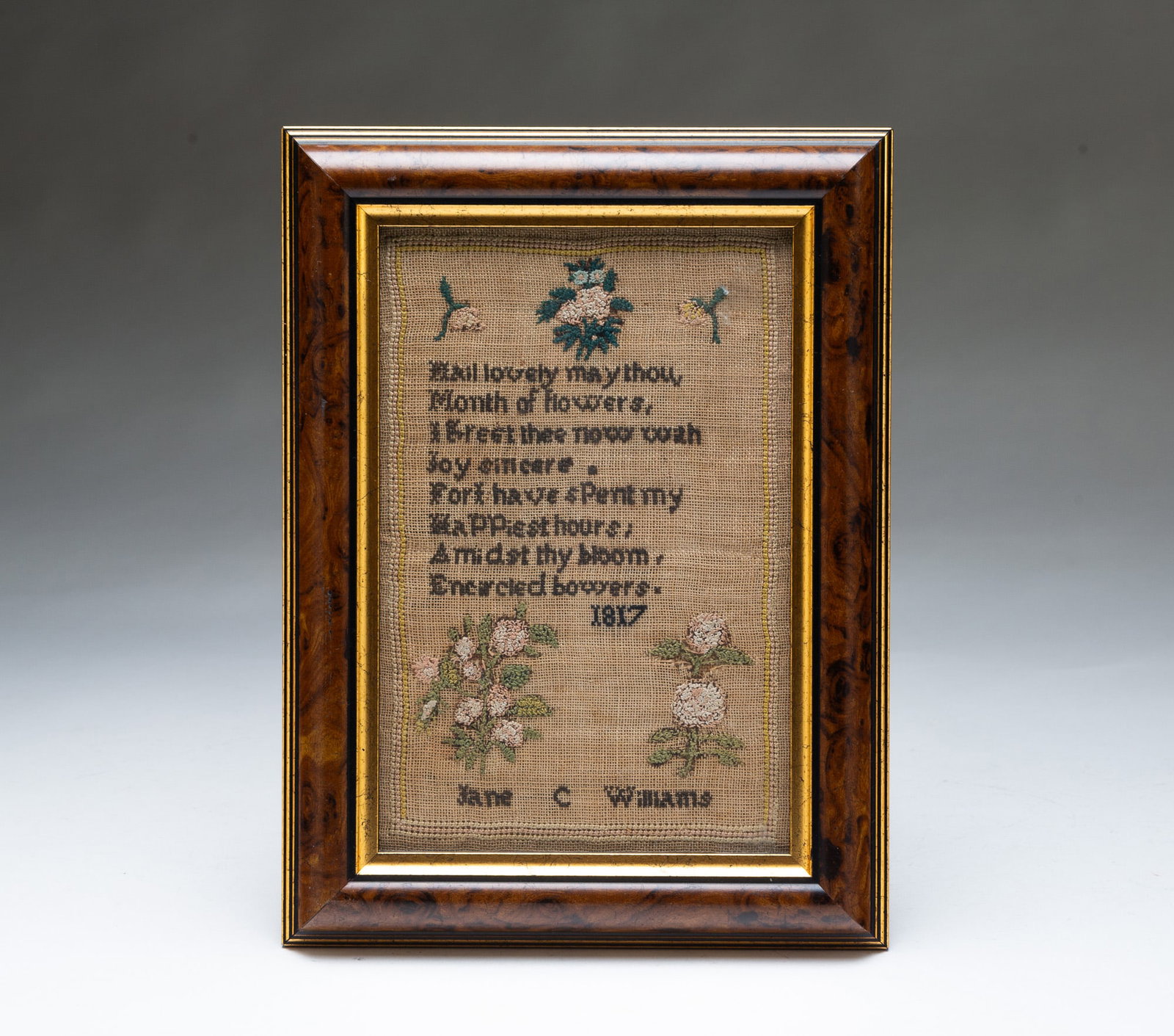 DIMINUTIVE NEEDLEWORK SAMPLER BY JANE C. WILLIAMS, DATED 1817.: DIMINUTIVE NEEDLEWORK SAMPLER BY JANE C. WILLIAMS, DATED 1817. American, 19th Century. Colored thread on linen. A three-line border containing flowers, poetic verse, and signed "1817 Jane C Williams".