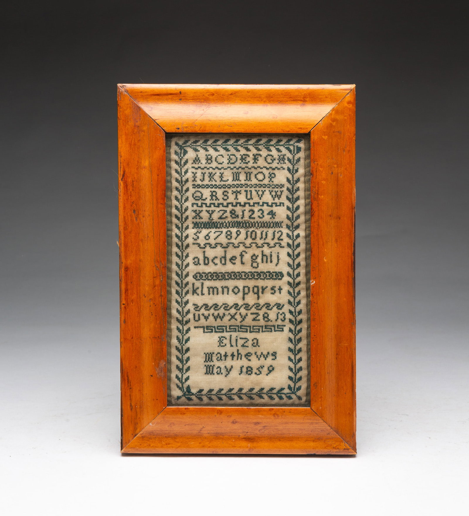 NEEDLEWORK SAMPLER WROUGHT BY ELIZA MATTHEWS.: NEEDLEWORK SAMPLER WROUGHT BY ELIZA MATTHEWS. American, Dated May 1859. Colored thread on linen. Rows of alphabets and numerals, various line borders, signed "Eliza Matthews May 1859", and all inside 
