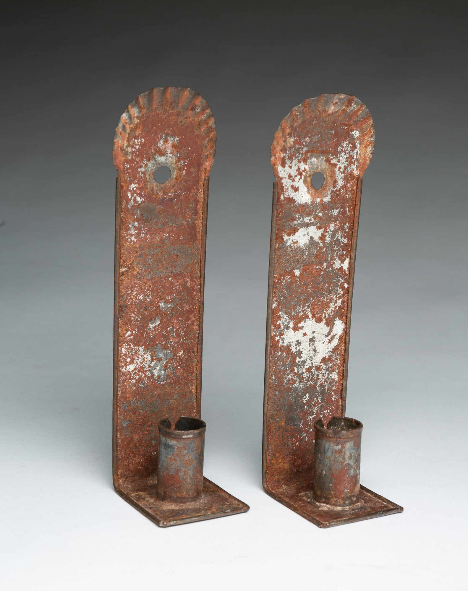 PAIR OF DIMINUTIVE TIN CANDLE SCONCES.: PAIR OF DIMINUTIVE TIN CANDLE SCONCES. American, 19th Century. Crimped three-quarter round top edge, straight backs, square pans, and single candle socket, with reflective surface and folded edges.