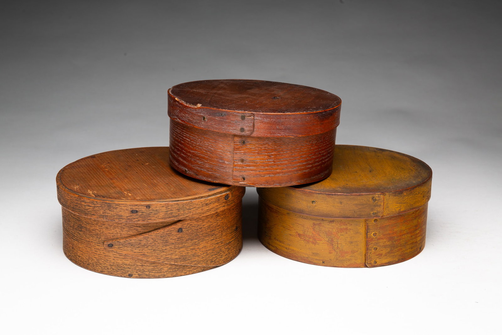 THREE BENTWOOD PANTRY BOXES.: THREE BENTWOOD PANTRY BOXES. American, 19th Century. The largest is oak and pine with Harvard joints and steel tacks, 2.75''h. 7"d. Middle size is pine and bass wood with lap joints, steel tacks, and