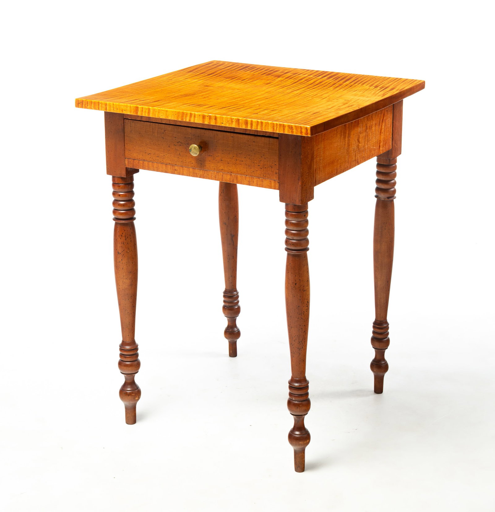 SHERATON TIGER MAPLE ONE DRAWER STAND.: SHERATON TIGER MAPLE ONE DRAWER STAND. American, First half 19th Century. One board top, dovetailed drawer, and turned legs. 26.75"h. 20"w. 19.5"d. Provenance: From the Lifetime Collection of Charles 