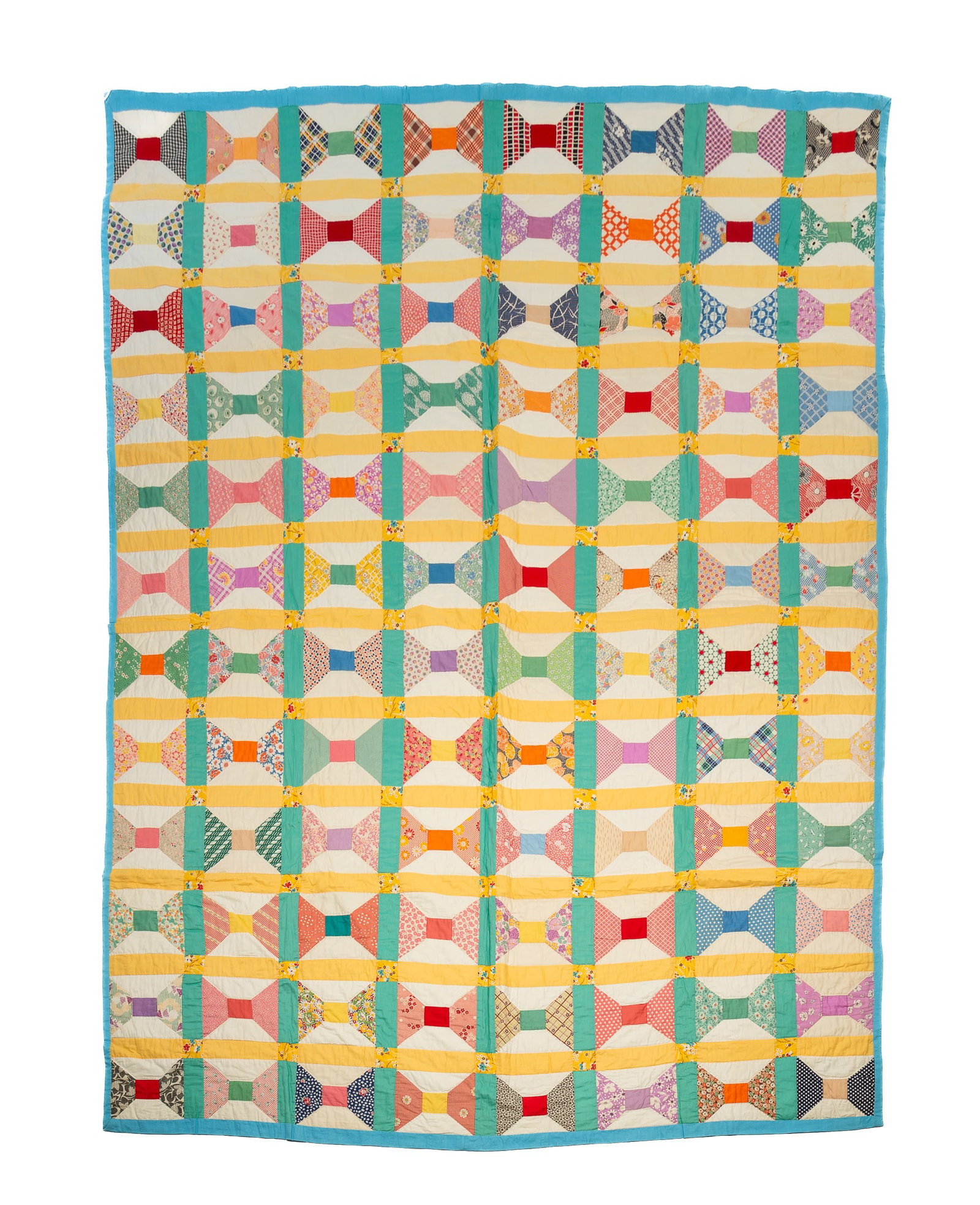 COTTON PIECEWORK BOW TIE QUILT.: COTTON PIECEWORK BOW TIE QUILT. American, mid-20th Century. Hand-stitched in patterned and solid fabrics. Provenance: From the Lifetime Quilt and Textile Collection of Louise A. Veninga (Santa Cruz, C