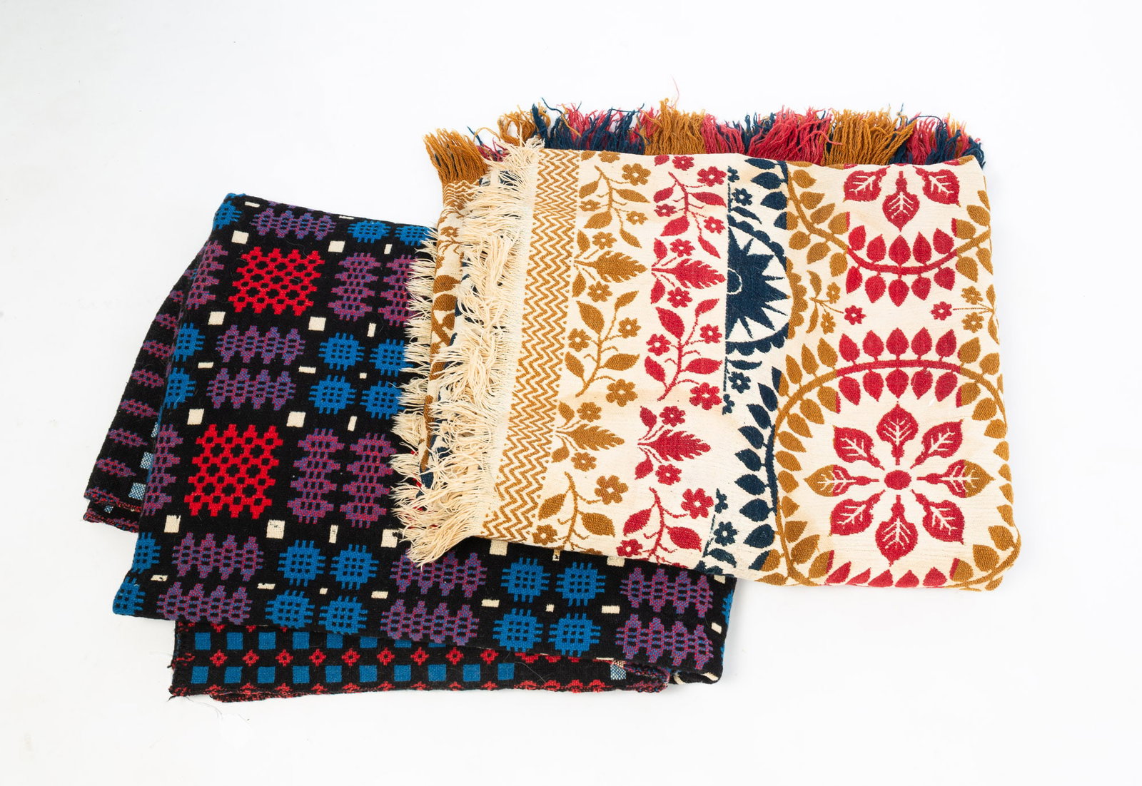 TWO SUMMER-WINTER COVERLETS.: TWO SUMMER-WINTER COVERLETS. An American three-color coverlet with corner blocks having four stars, J.B. initials, and dated 1857. Floral border and pattern in red, gold, and blue on a cream field,