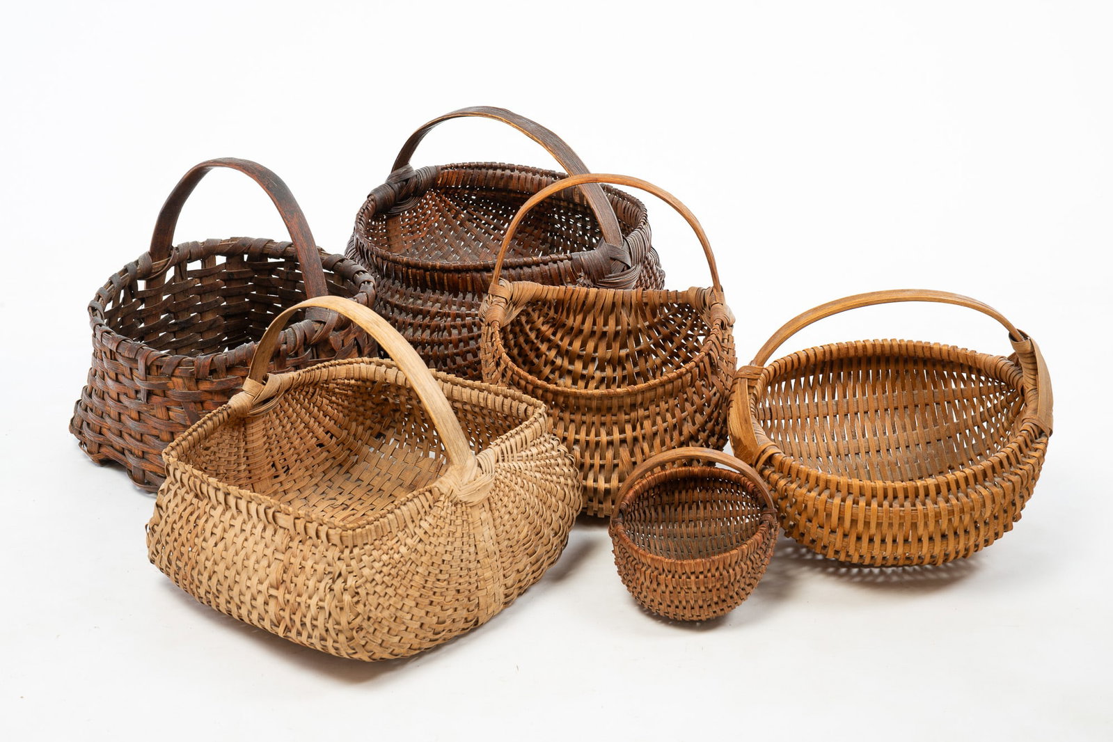 SIX WOVEN SPLINT BENTWOOD HANDLED BASKETS. (1 of 5)