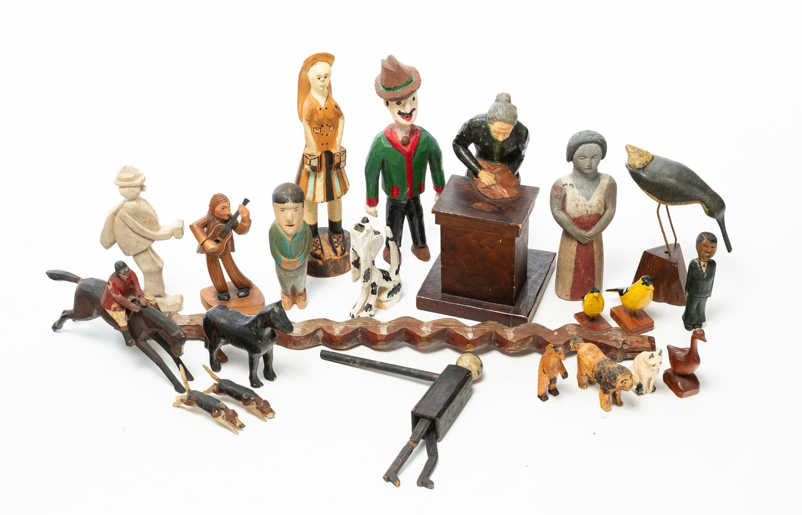 GROUP OF FOLKSY CARVINGS INCLUDING ANIMALS, PEOPLE, AND A HORSE AND RIDER.: GROUP OF FOLKSY CARVINGS INCLUDING ANIMALS, PEOPLE, AND A HORSE AND RIDER. American, 20th Century. A diverse assemblage of hand-carved wooden figures, including a horse and rider, a shorebird, a