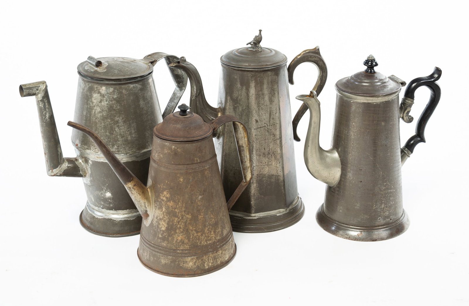 FOUR TINNED SHEET METAL COFFEE POTS.: FOUR TINNED SHEET METAL COFFEE POTS. American, Mid-19th Century. Tallest has copper label soldered to base, stamped "F.A.FRANKLIN", pheasant finial, fluted spout, paneled body, and round stepped