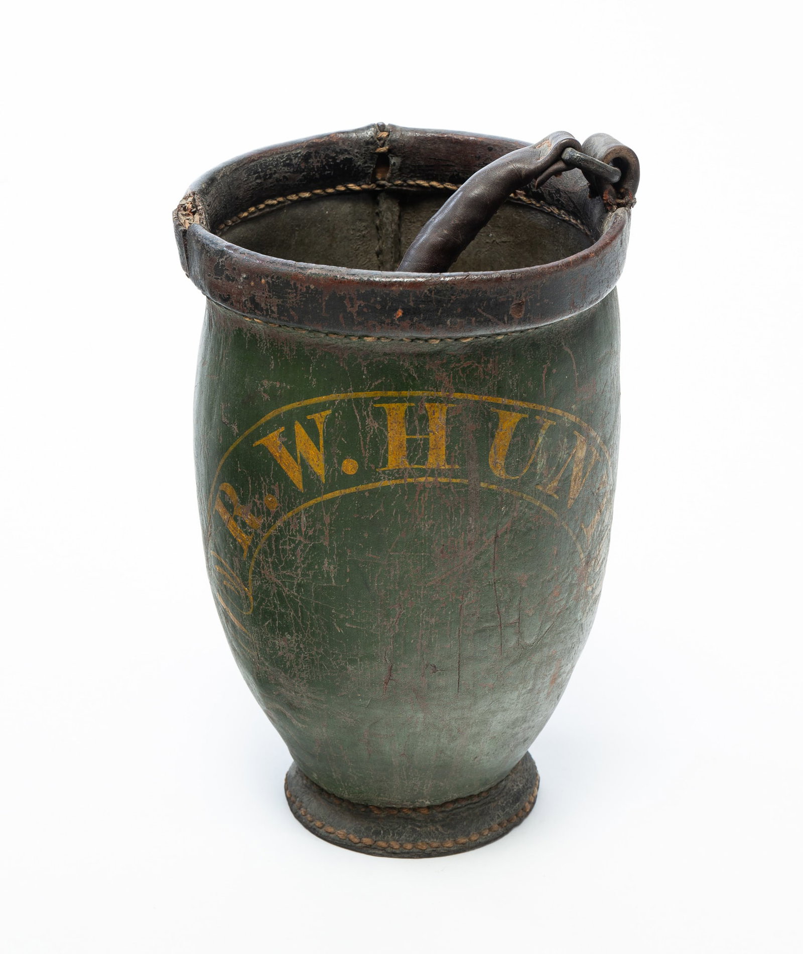 PAINT-DECORATED LEATHER "R.W. HUNT" FIRE BUCKET.: PAINT-DECORATED LEATHER "R.W. HUNT" FIRE BUCKET. American, 19th Century. Having a leather swing handle above green-painted body with yellow letters reading "R.W. HUNT." 13"h. (not including handle).