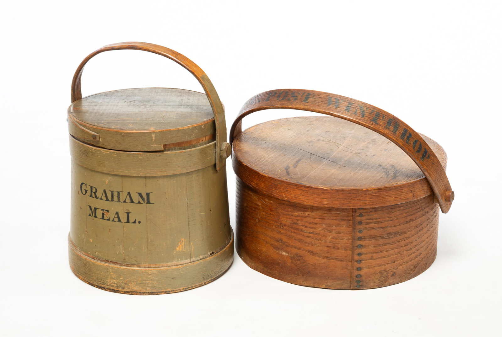 BENTWOOD HANDLED CARRIER AND FIRKIN.: BENTWOOD HANDLED CARRIER AND FIRKIN. American, 19th Century. Stave constructed firkin with wooden bands, green paint, and a stenciled label reading "GRAHM MEAL", 10"h. 10"w. at bottom. And a lidded