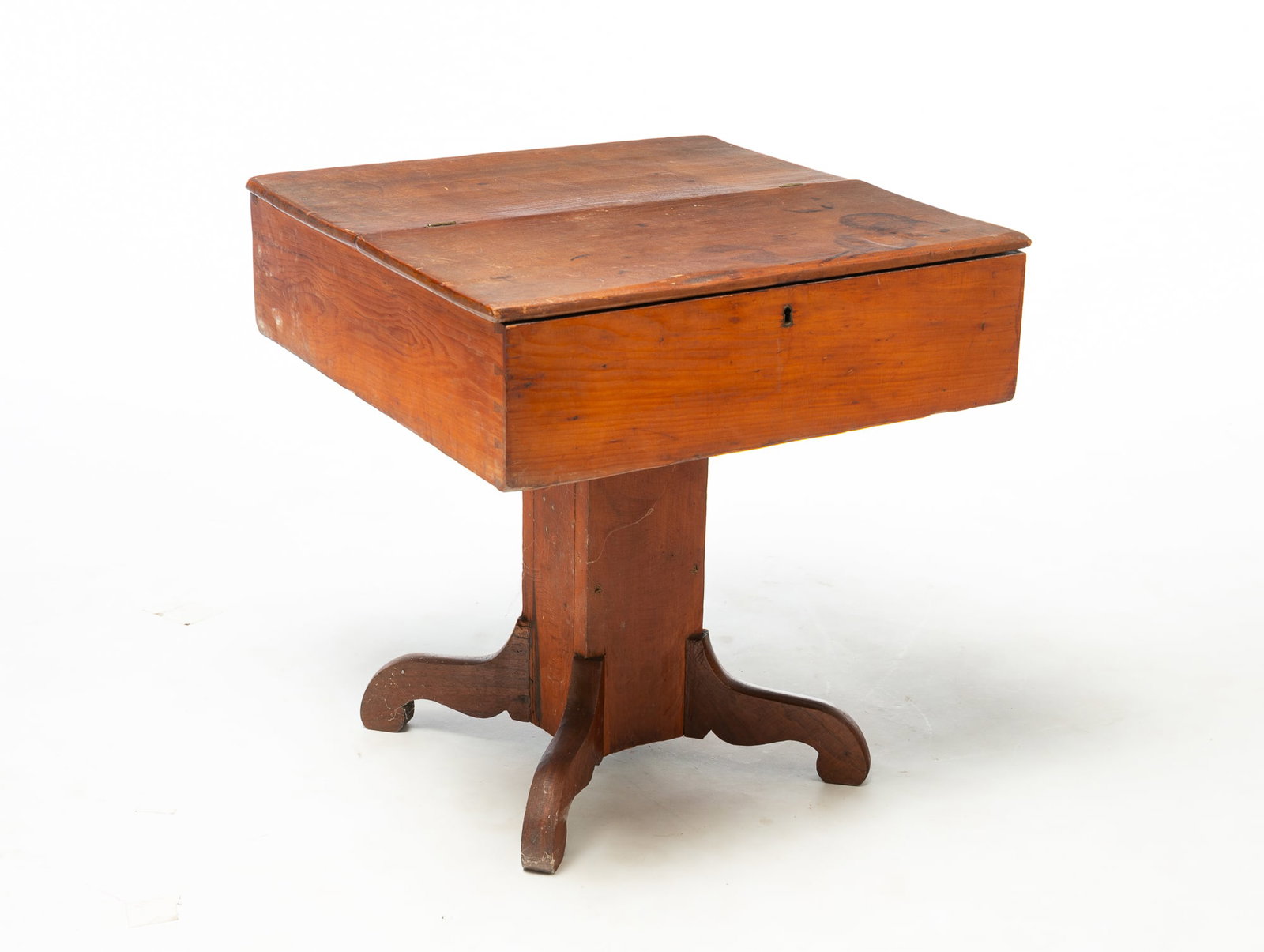 COUNTRY EMPIRE PEDESTAL-BASE YOUTH DESK.: COUNTRY EMPIRE PEDESTAL-BASE YOUTH DESK. American, 19th Century. Pine. Hinged lid with interior well, dovetailed square pedestal, and scrolled legs. 21.5"h. 20.75"square. Provenance: The Lifetime