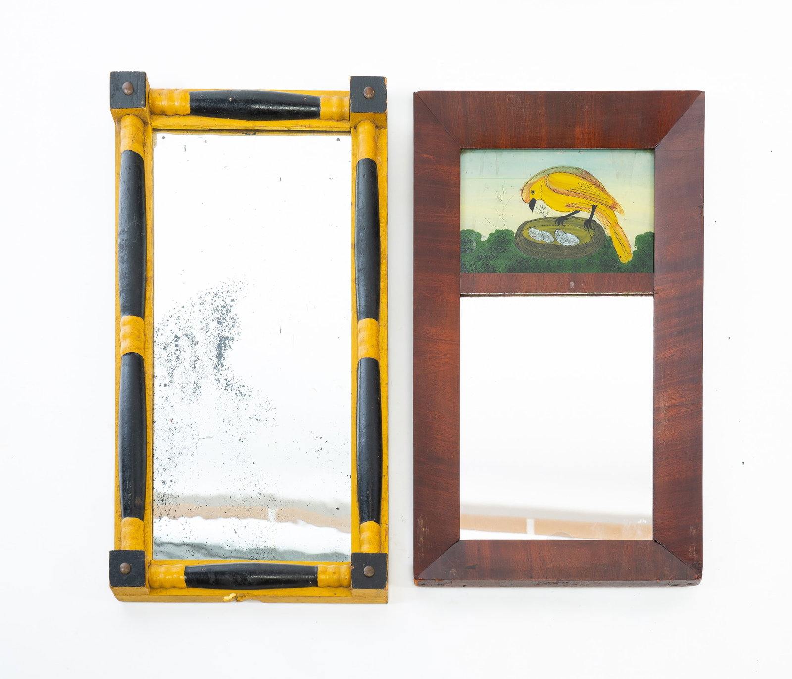 TWO EMPIRE MIRRORS.: TWO EMPIRE MIRRORS. American, First half 19th Century. One with beveled mahogany veneered frame and a reverse painted tablet of a yellow bird on a nest with four eggs, 19.75"h. 11.75"w., and a mirror