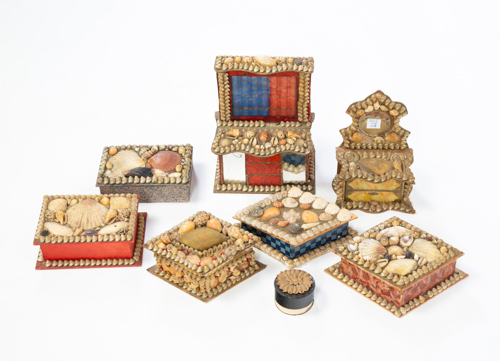 EIGHT SHELL ART TRINKET BOXES.: EIGHT SHELL ART TRINKET BOXES. 20th Century. Bookcase shaped with hinged lid, 6.75"h., dresser shaped with hinged lid, 6.25"h., three diamond-shaped boxes, two rectangular boxes, and a round patch