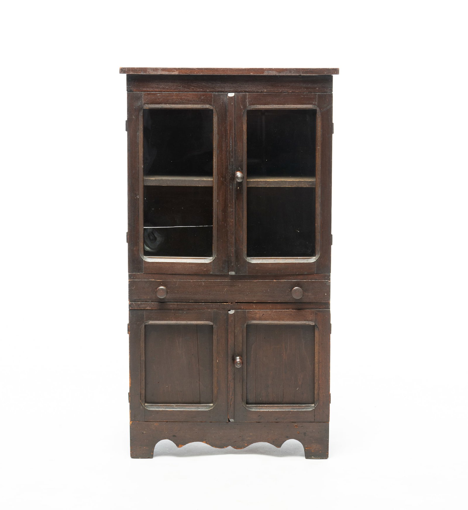 DIMINUTIVE POPLAR CHILD'S FLATWALL CUPBOARD.: DIMINUTIVE POPLAR CHILD'S FLATWALL CUPBOARD. American Late 19th Century. One-board top, ends with half round cut outs, two upper single pane glass doors, wick waist drawer, two lower single panel