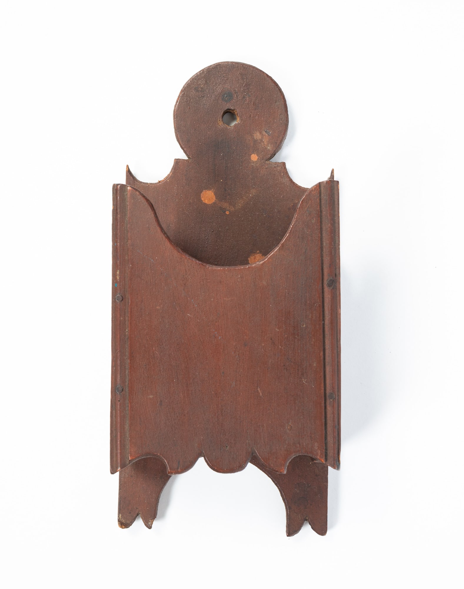 CARVED AND PAINTED WOODEN HANGING MORTAR AND PESTLE HOLDER.: CARVED AND PAINTED WOODEN HANGING MORTAR AND PESTLE HOLDER. American, 19th Century. Pine. Lollipop and scrolled back, shaped sides, and shaped front, in an allover alligatored brown paint. 12.5"h.