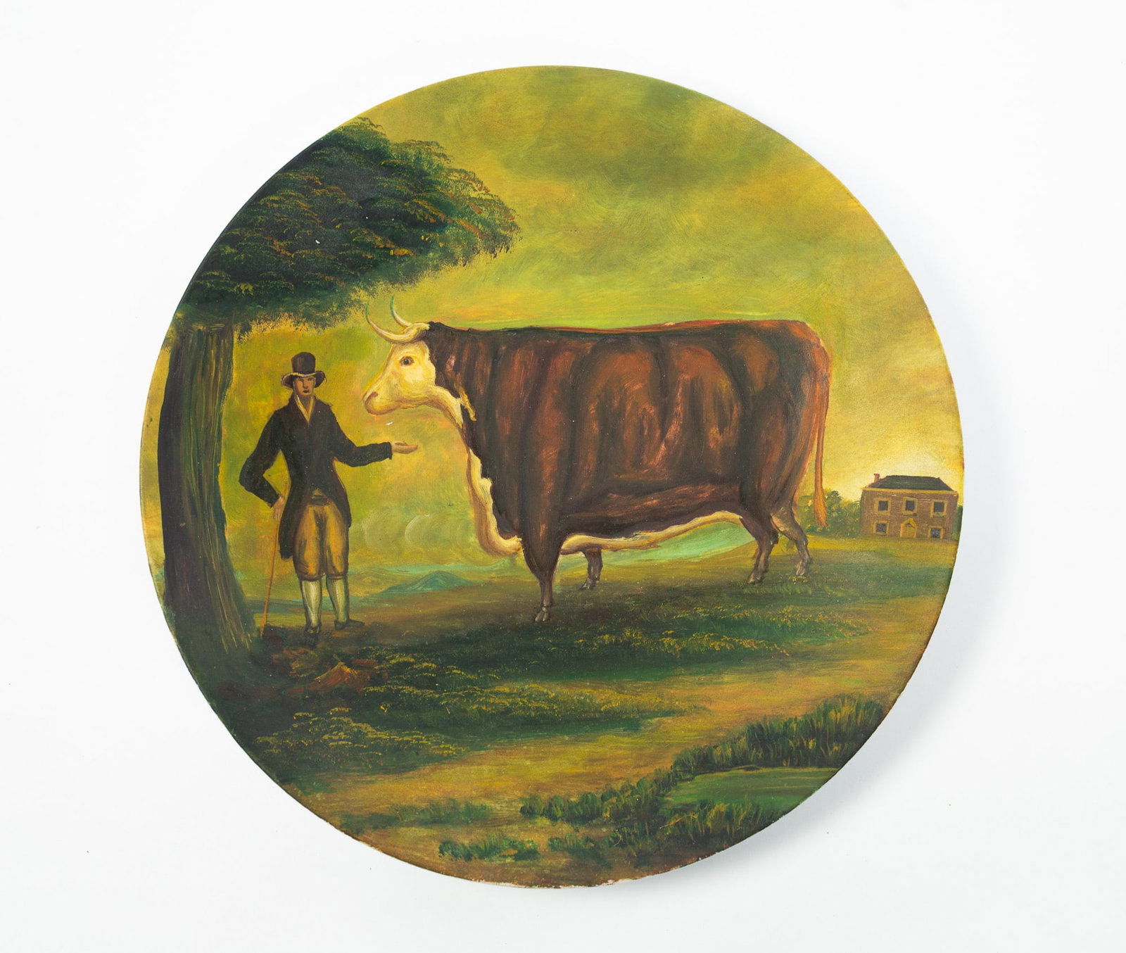 FOLK ART PAINTED PORCELAIN CHARGER WITH GENTLEMAN AND PRIZED HEREFORD BULL.: FOLK ART PAINTED PORCELAIN CHARGER WITH GENTLEMAN AND PRIZED HEREFORD BULL. Possibly English, 19th Century. Depicting a gentleman standing to the left of his prized Hereford bull within a verdant land