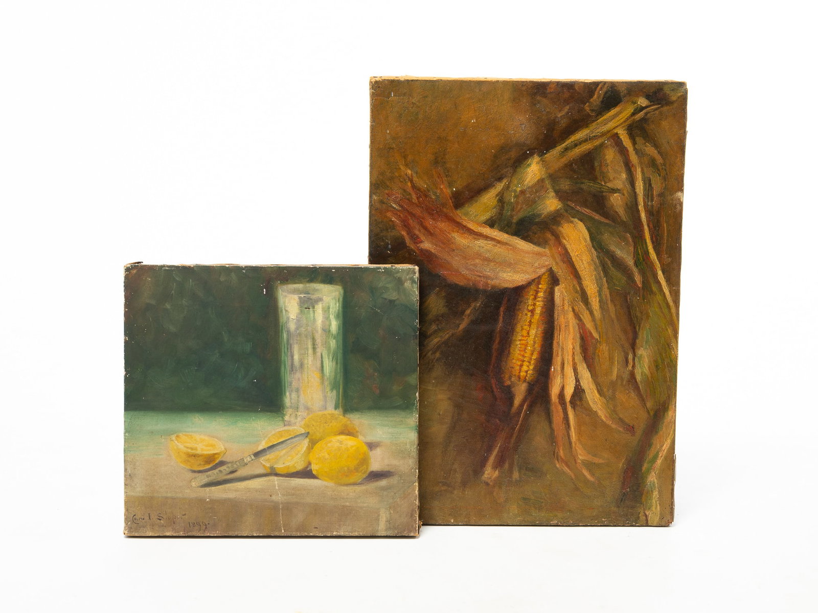 TWO OIL ON CANVAS STILL LIFES.: TWO OIL ON CANVAS STILL LIFES. American, Late 19th Century. A tumbler and lemons, one sliced in half and knife on a white tablecloth, signed Cora L. Slope 1899, unframed, 12"h. 13"w., and an ear of