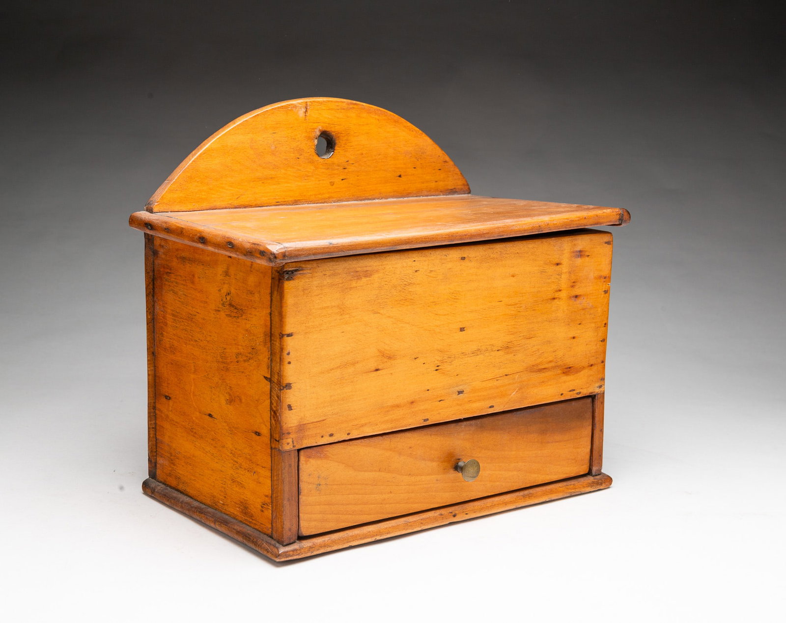 HANGING SALT BOX WITH DRAWER.: HANGING SALT BOX WITH DRAWER. American, 19th Century. Mixed woods. Simple construction with square nails. Having an arched back, lift lid, double-well interior, and single drawer with fitted