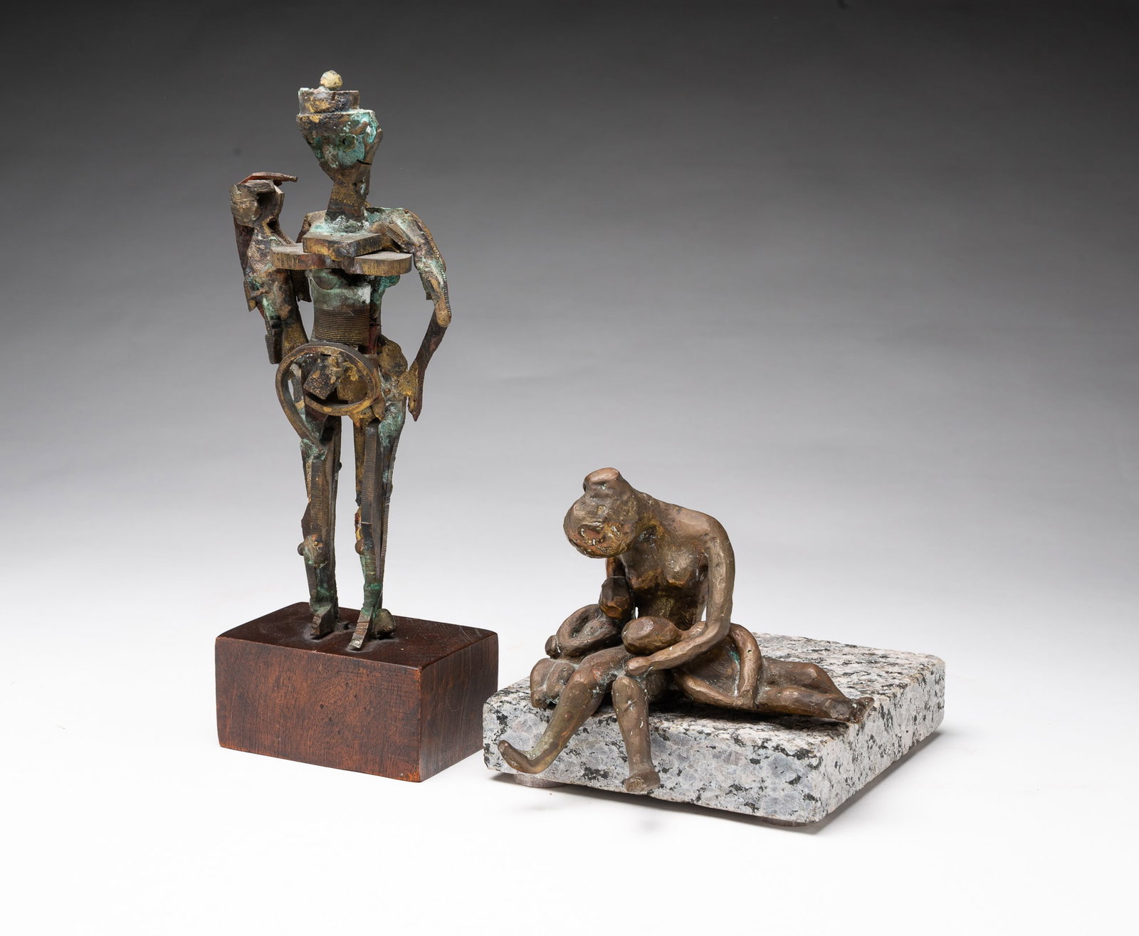 TWO DIMINUTIVE METAL SCULPTURES OF MOTHER AND CHILD, INCL. HY T. SNELL (AMERICAN, 1919-2017).: TWO DIMINUTIVE METAL SCULPTURES OF MOTHER AND CHILD, INCL. HY T. SNELL (AMERICAN, 1919-2017). Late 20th or early 21st Century. Standing figure with child on hip made of patinated metal parts on wooden