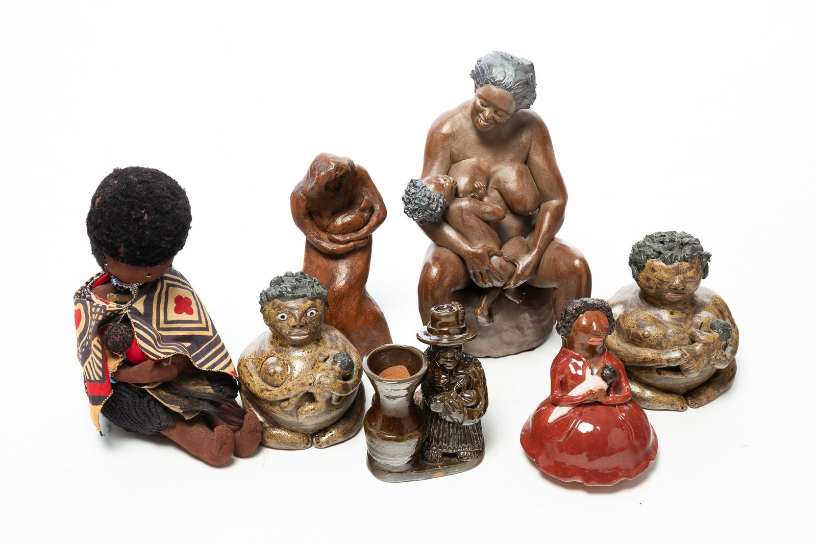 SEVEN FIGURINES OF NURSING MOTHERS, MOSTLY GLAZED REDWARE INCL. TURKEY MOUNTAIN (ARMUCHEE, GEORGIA).: SEVEN FIGURINES OF NURSING MOTHERS, MOSTLY GLAZED REDWARE INCL. TURKEY MOUNTAIN (ARMUCHEE, GEORGIA). American, 20th and 21st Centuries. Three glazed redware figures signed "Turkey Mt. Phry, Armuchee,
