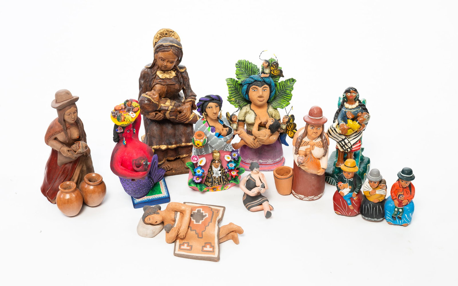 NINE FOLK ART FIGURINES OF NURSING MOTHERS, INCL. JOSEFINA AGUILAR (MEXICAN, B. 1945).: NINE FOLK ART FIGURINES OF NURSING MOTHERS, INCL. JOSEFINA AGUILAR (MEXICAN, B. 1945). Peruvian, Native American, and Mexican, 20th Century. Mostly painted or glazed clay, in various forms, some