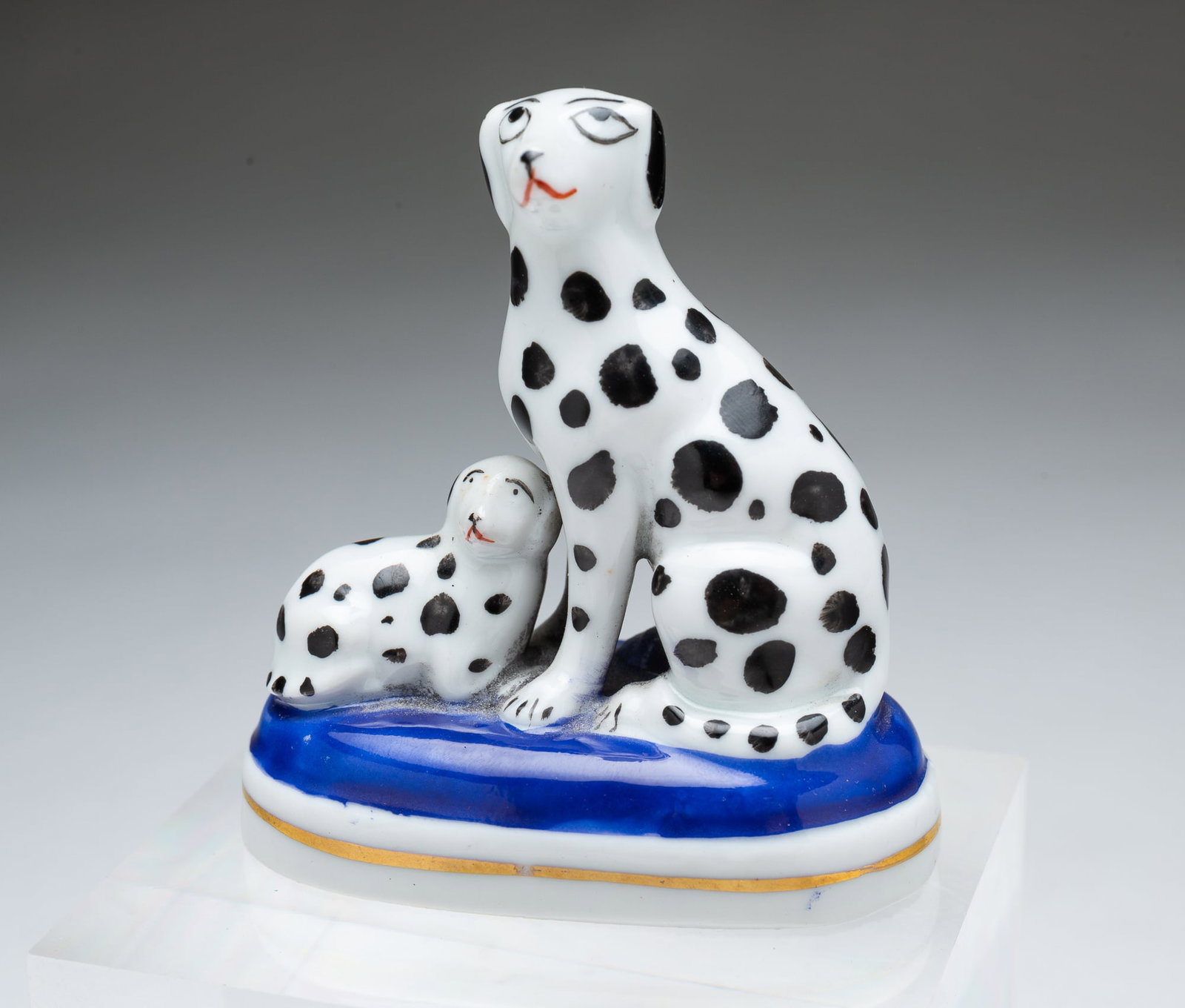 FRENCH SAMSON THE IMITATOR, DALMATIAN FIGURINE.: FRENCH SAMSON THE IMITATOR, DALMATIAN FIGURINE. Late 19th Century. Porcelain. Dalmatian mother and pup on an oval, blue, white, and gold base. Chelsea anchor mark. 2.75"h.