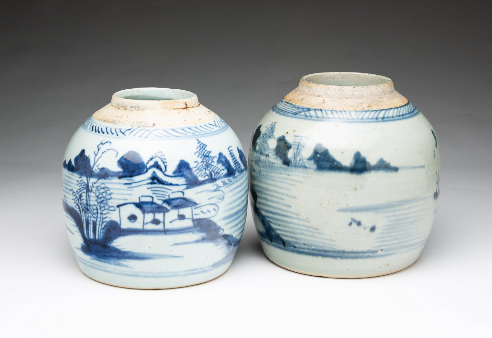 TWO CHINESE EXPORT BLUE AND WHITE CANTON PORCELAIN GINGER JARS.: TWO CHINESE EXPORT BLUE AND WHITE CANTON PORCELAIN GINGER JARS. 19th Century (ca. 1840). Each of bulbous form with depictions of a figure fishing, trees, mountains, water, pagodas, and boats. No lids.