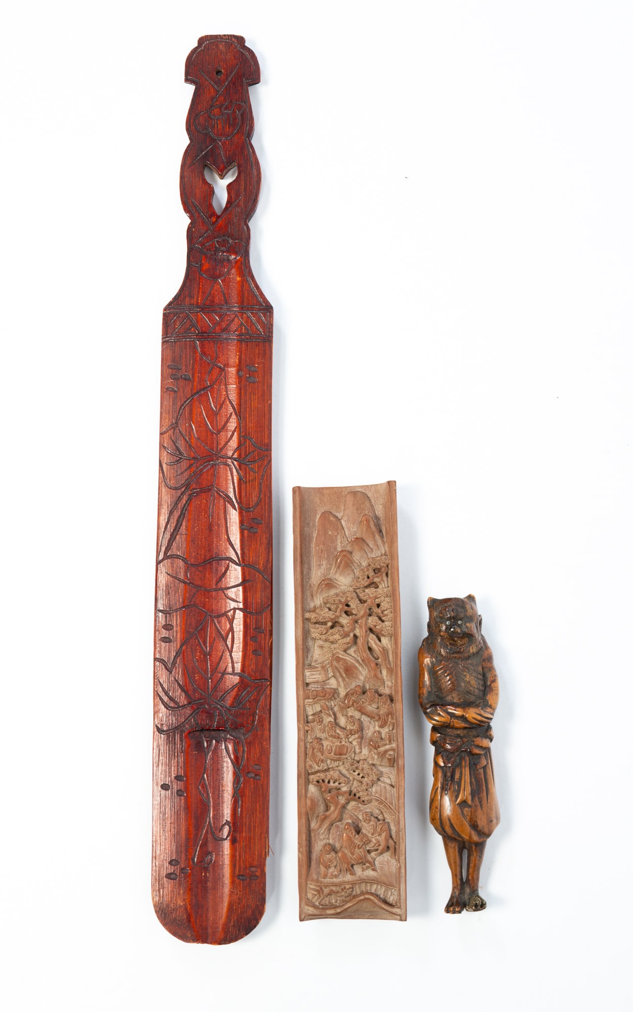 THREE CARVED WOOD ASIAN ITEMS.: THREE CARVED WOOD ASIAN ITEMS. Japan and China, 19th and 20th Centuries. A rare and early Japanese netsuke of Sennin, possibly by Suzan, 6"h., a Japanese carved wood page turner, 17.25"l., and a Chine