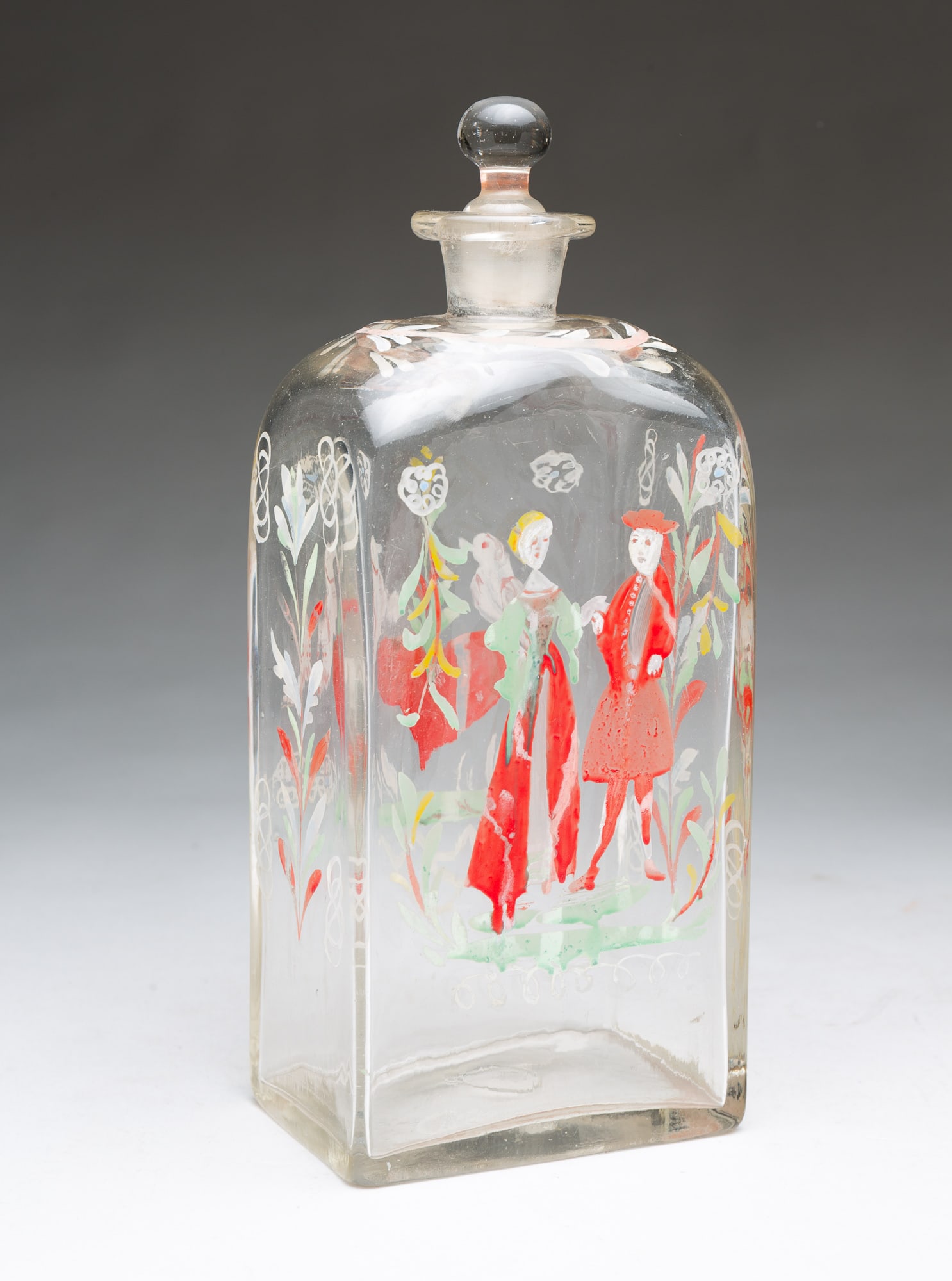 HALF-POST BLOWN GLASS "STIEGEL-TYPE" DECANTER WITH HAND-PAINTED POLYCHROME DECORATION.: HALF-POST BLOWN GLASS "STIEGEL-TYPE" DECANTER WITH HAND-PAINTED POLYCHROME DECORATION. Likely Bohemia, 18th or 19th Century. Rectangular bottle with glass stopper, a foliate wreath encircling the neck