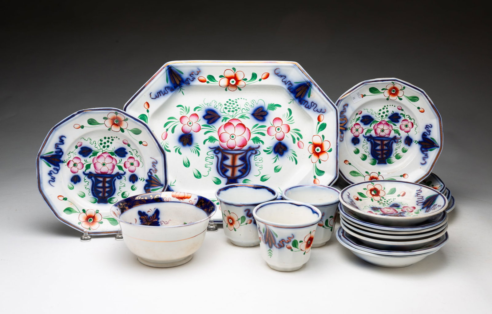GROUP OF GAUDY URN PATTERN IRONSTONE CHINA.: GROUP OF GAUDY URN PATTERN IRONSTONE CHINA. England, 19th Century. An octagonal platter, plates in various sizes, bowls, saucers, and handleless cups. Platter, 13.5"w. 10"d. Provenance: From the