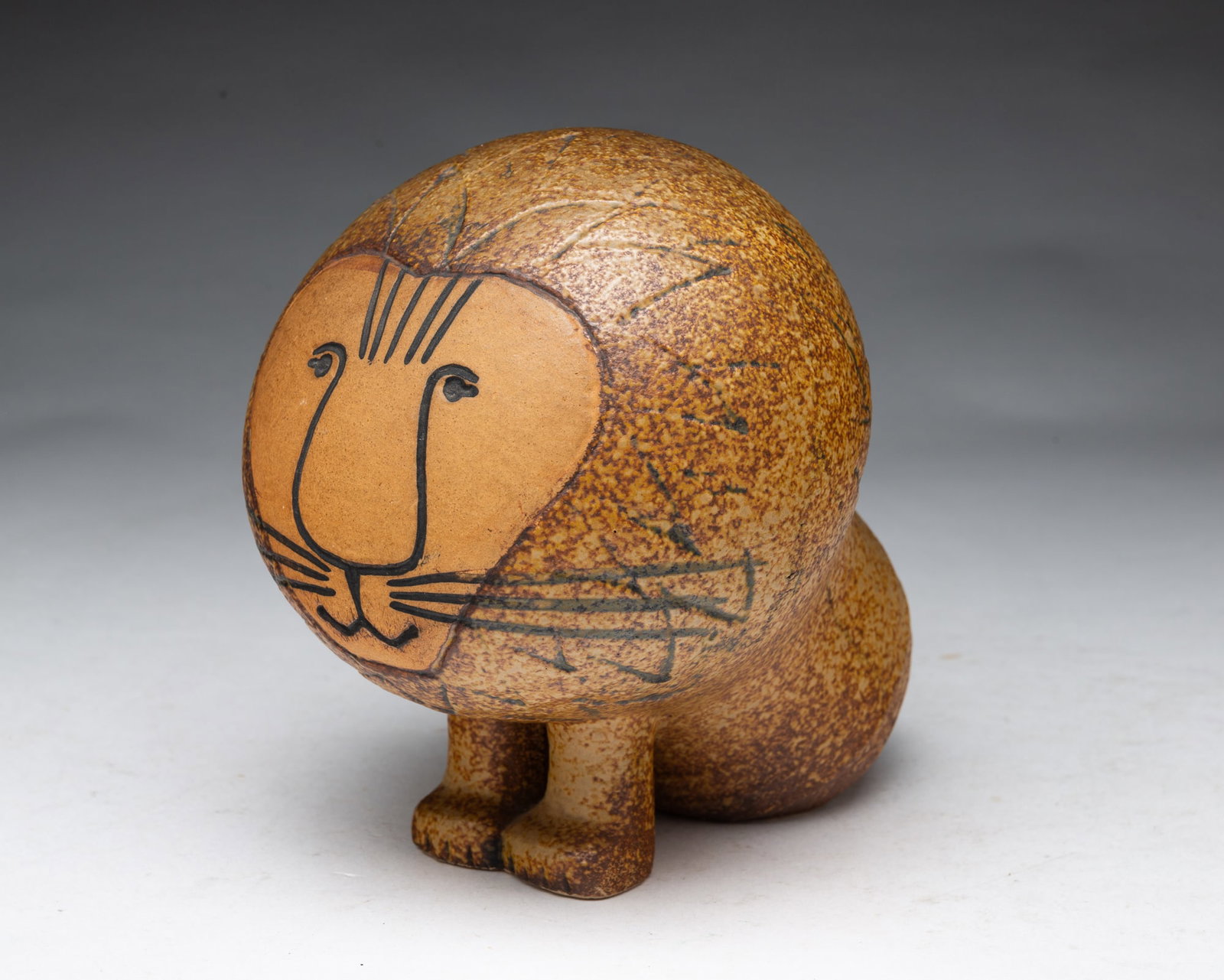 LISA LARSON (SWEDEN, 1931-2024) FOR GUSTAVSBERG CERAMIC LION FIGURE.: LISA LARSON (SWEDEN, 1931-2024) FOR GUSTAVSBERG CERAMIC LION FIGURE. Sweden, 20th Century. From the Afrika Series. A ceramic lion with a bulbous head and engraved features. Retains the paper label to