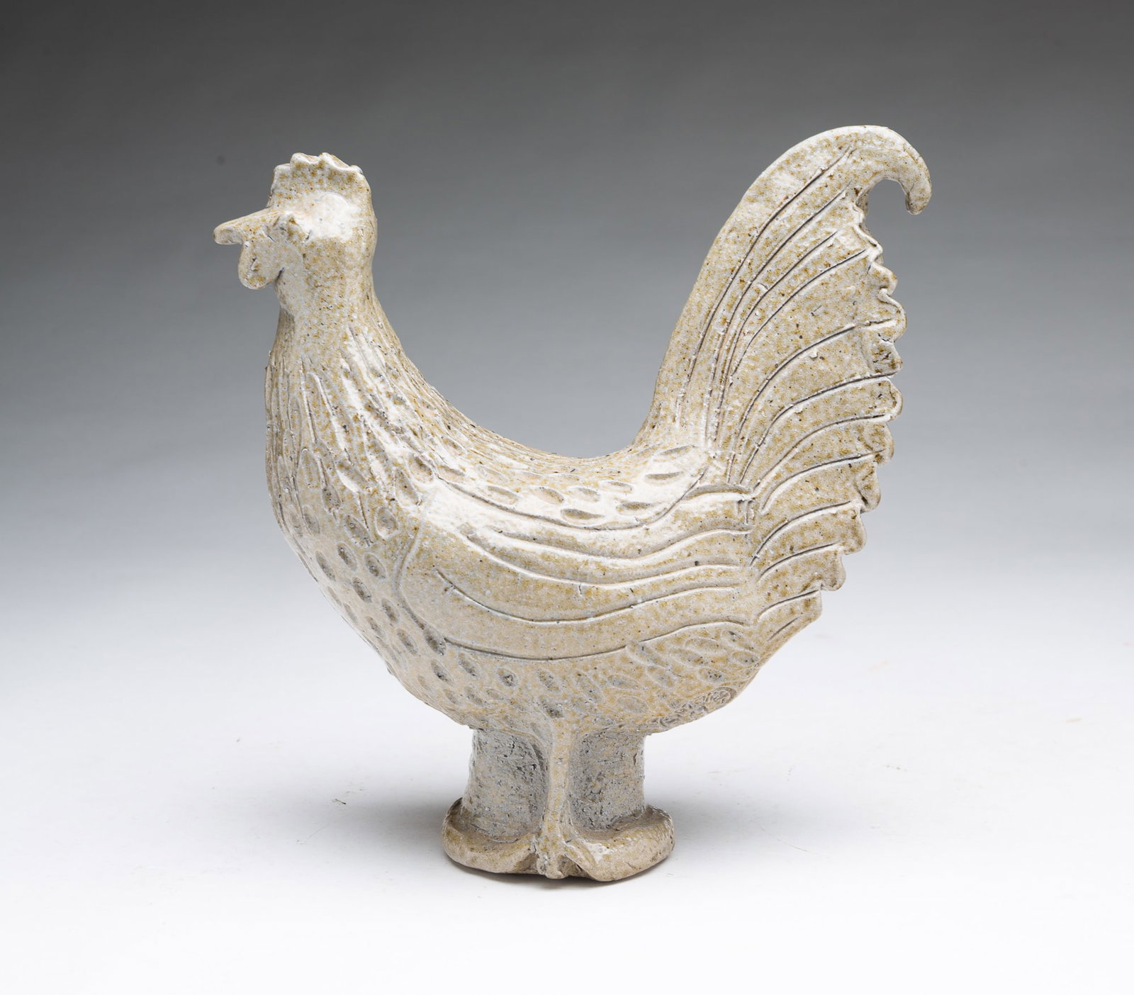 CHARLES MOORE (1949–2014) JUGTOWN POTTERY (SEAGROVE, NORTH CAROLINA) FOLK ART ROOSTER.: CHARLES MOORE (1949–2014) JUGTOWN POTTERY (SEAGROVE, NORTH CAROLINA) FOLK ART ROOSTER. American, dated 1987. Salt-glazed pottery rooster with an allover mottled tan glaze, molded head, tail