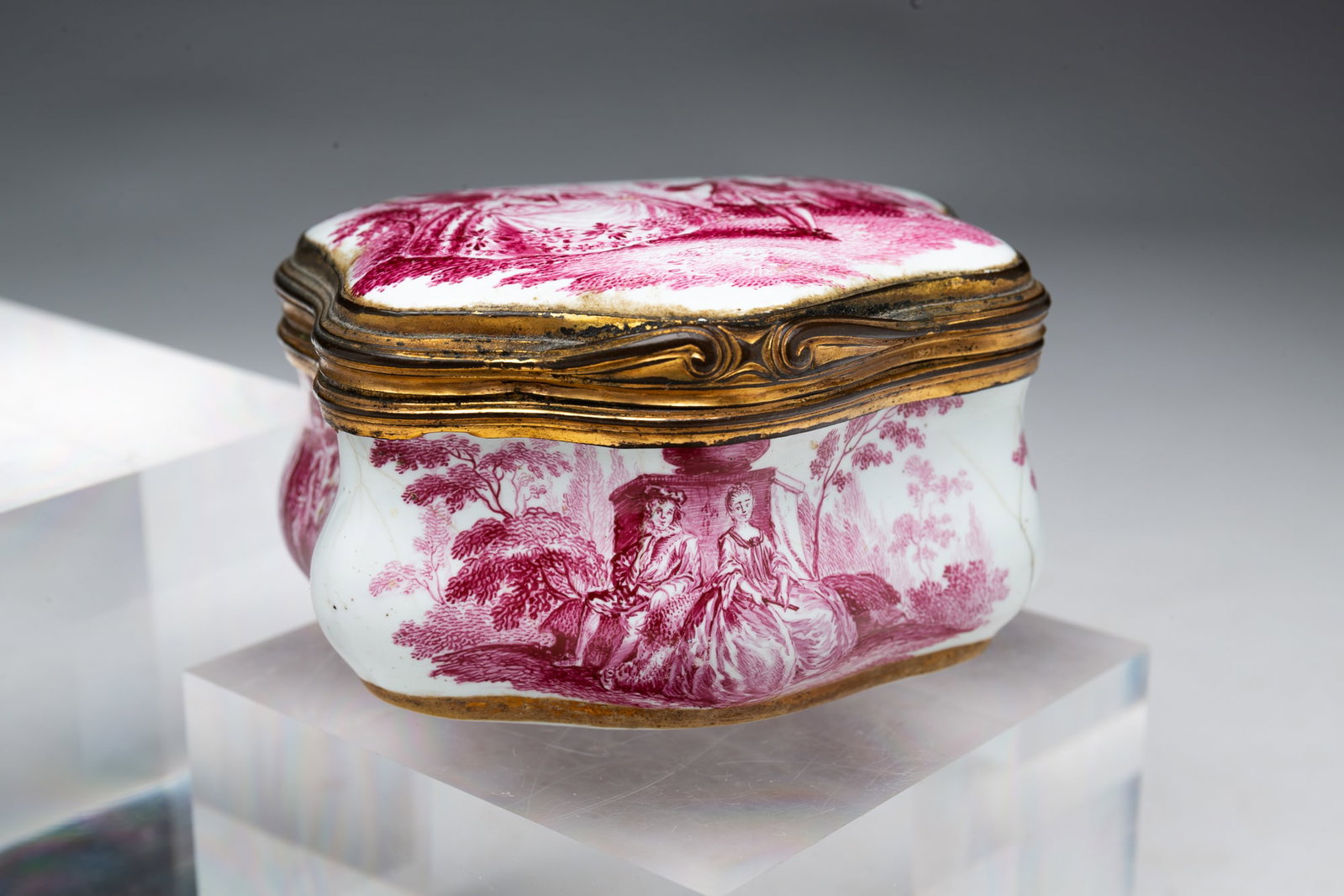 CARTOUCHE FORM EROTIC ENAMEL SNUFF BOX.: CARTOUCHE FORM EROTIC ENAMEL SNUFF BOX. English or European, 18th Century. Bombe form decorated with figures in landscapes, a nude reclining woman to inside lid. 2"h. 3.25"w.
