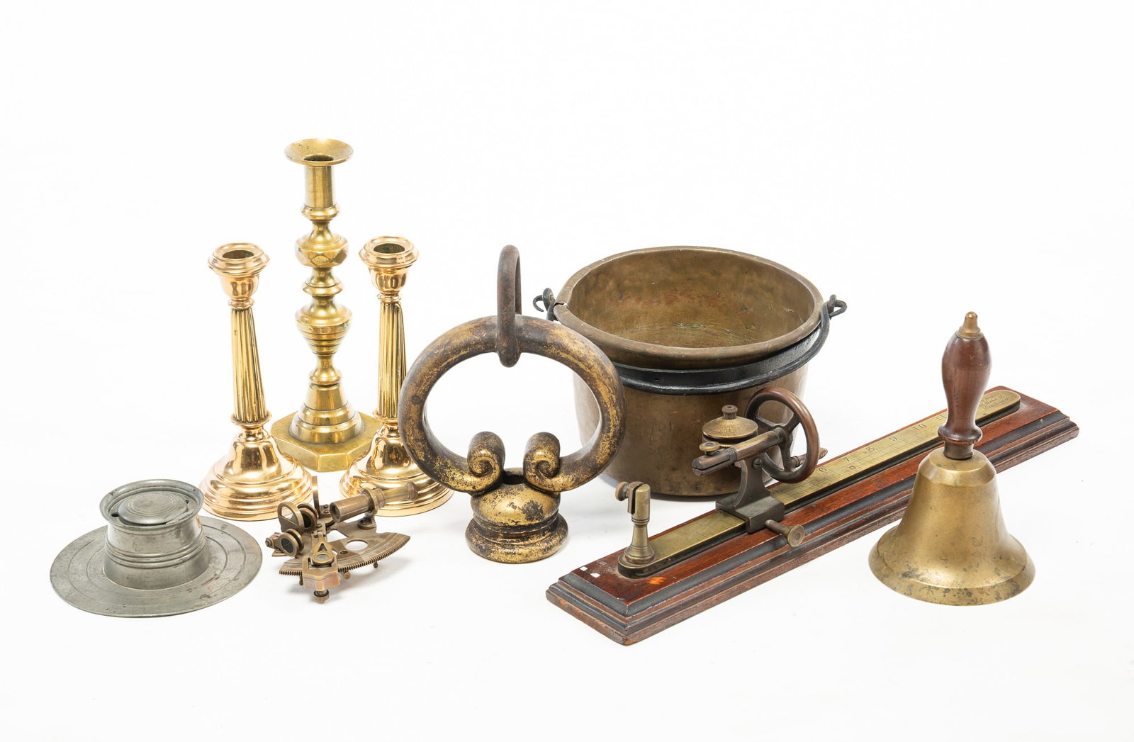 ECLECTIC GROUPING OF METAL ITEMS.: ECLECTIC GROUPING OF METAL ITEMS. American and English, Late 19th or Early 20th Century. A pair of bass candlesticks, a single inverted beehive, and diamond candlestick with pushup, a cast pewter
