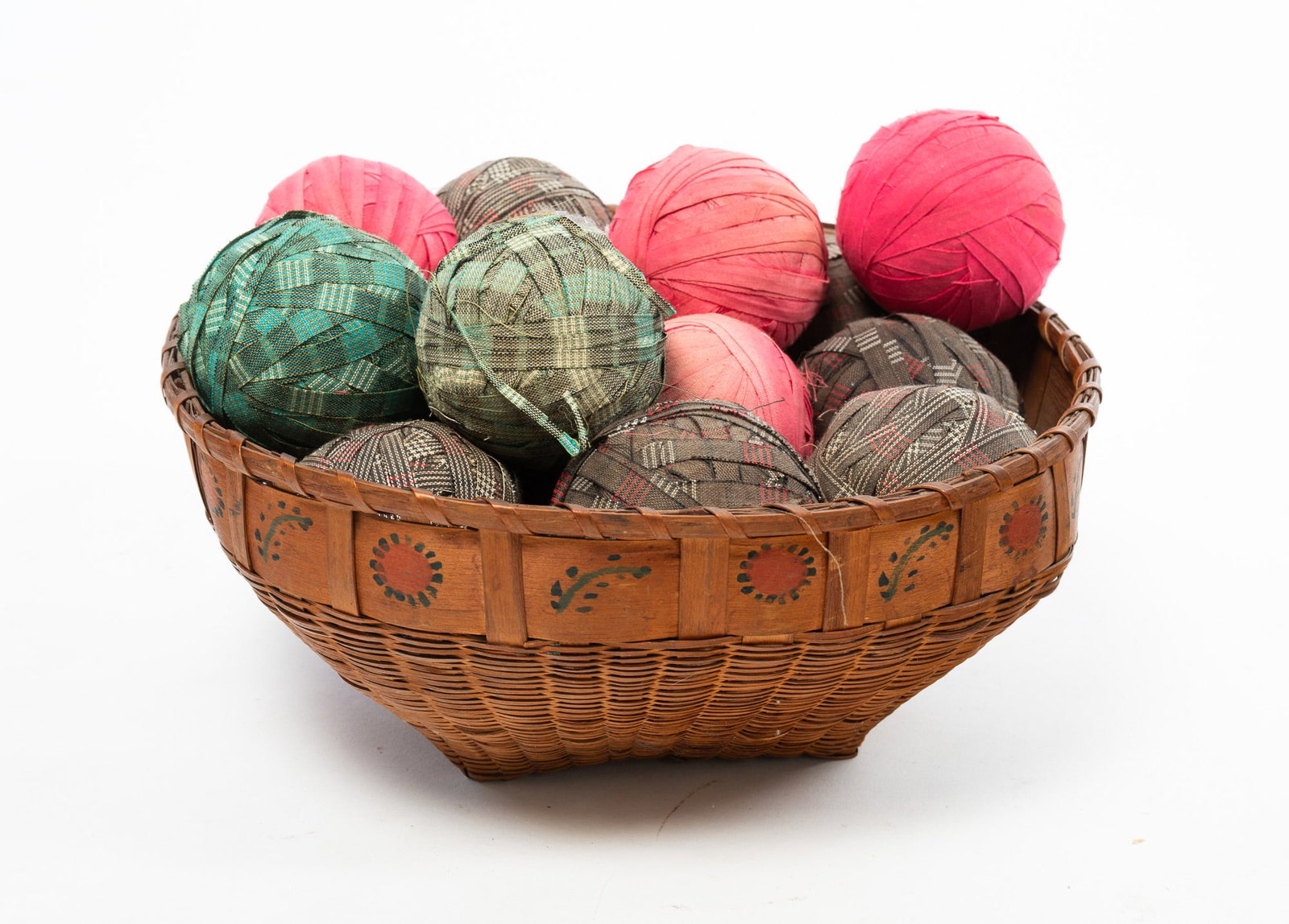 NATIVE AMERICAN BASKET FILLED WITH A COLLECTION OF CARPET BALLS. (1 of 6)