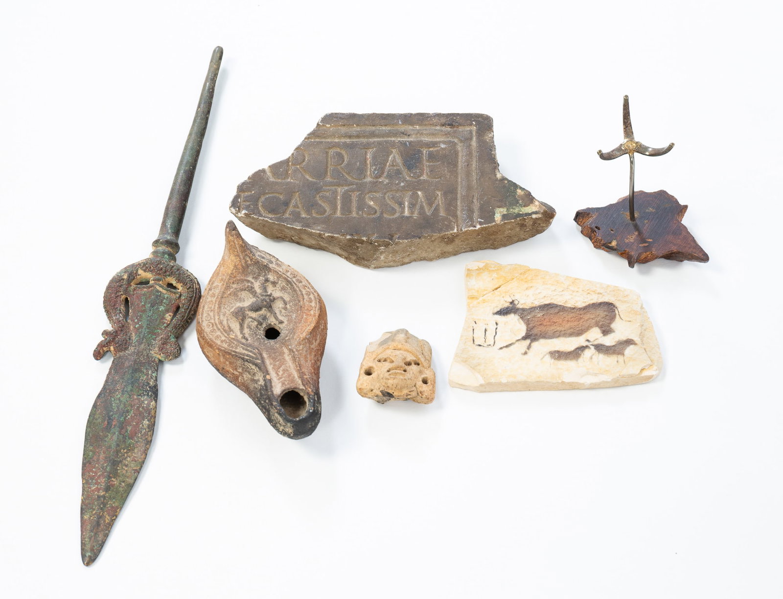 COLLECTION OF EARLY ARTIFACTS.: COLLECTION OF EARLY ARTIFACTS. Various, 19th and 20th Centuries. Including a Roman pottery grease lamp with a winged horse, a Roman wall fragment with a partial collection label to the back, an