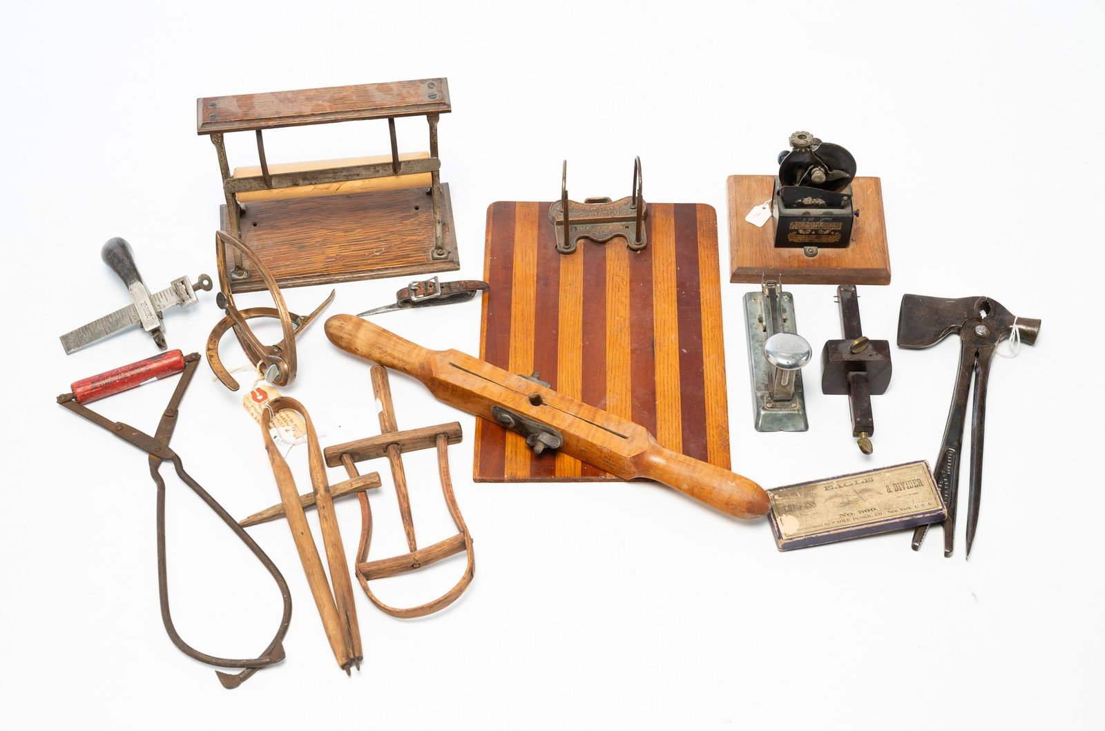 ECLECTIC GROUP OF FOURTEEN WOOD AND METAL TOOLS AND ACCESSORIES.: ECLECTIC GROUP OF FOURTEEN WOOD AND METAL TOOLS AND ACCESSORIES. American, Late 19th or Early 20th Century. Comprising a brass horseshoe measurer, a Farmer's Ever Ready Tool Kit, a Globe-Wernicke Co.