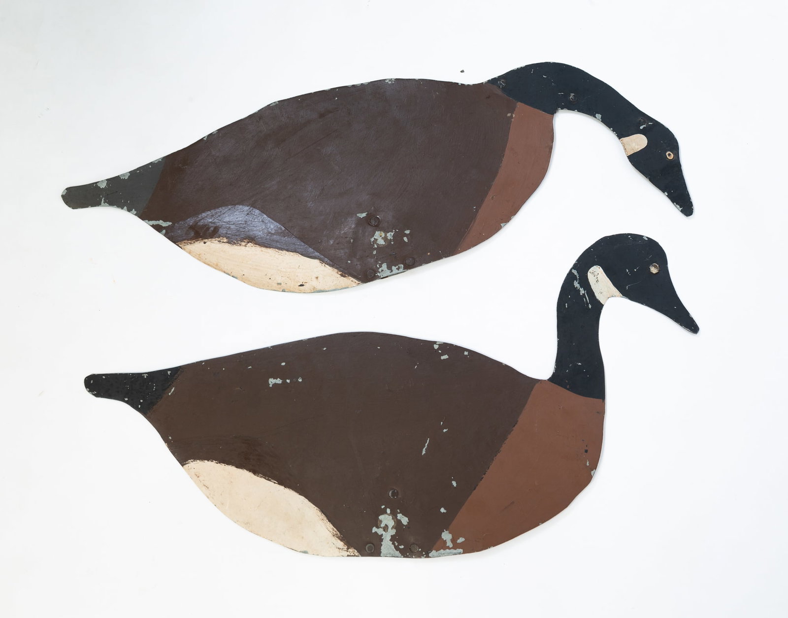 TWO PAINT-DECORATED SHEET METAL GOOSE DECOYS. (1 of 3)