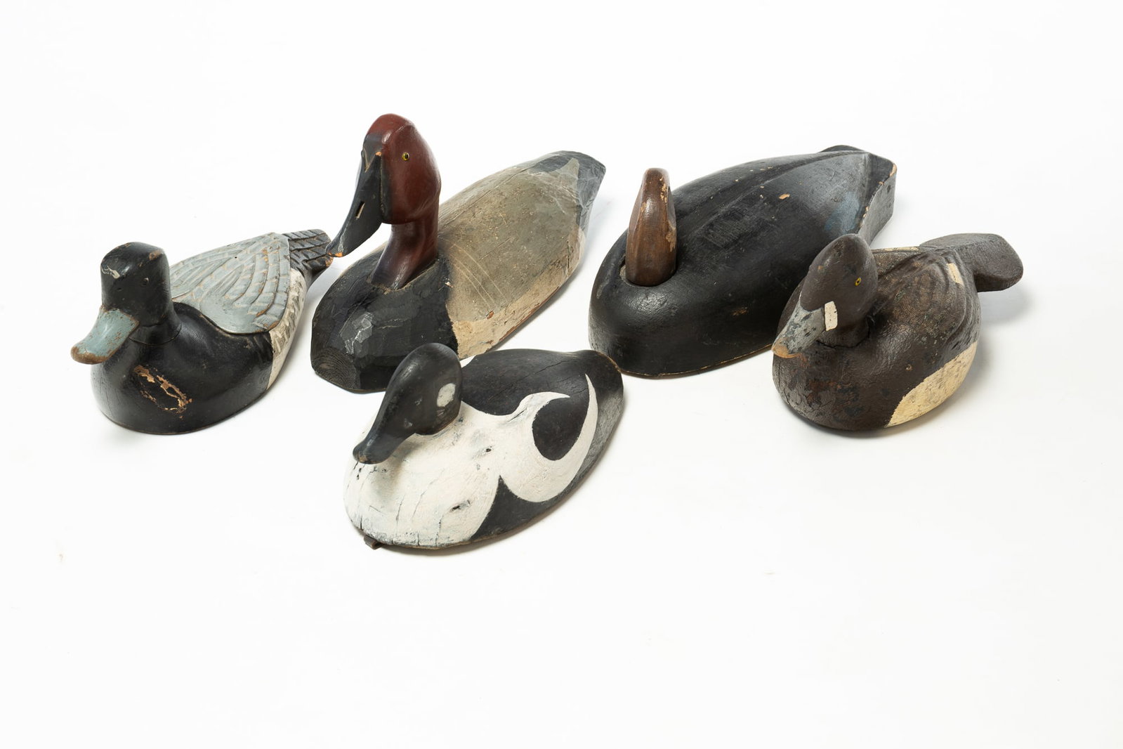 FIVE CARVED AND PAINT-DECORATED WORKING DUCK DECOYS. (1 of 6)