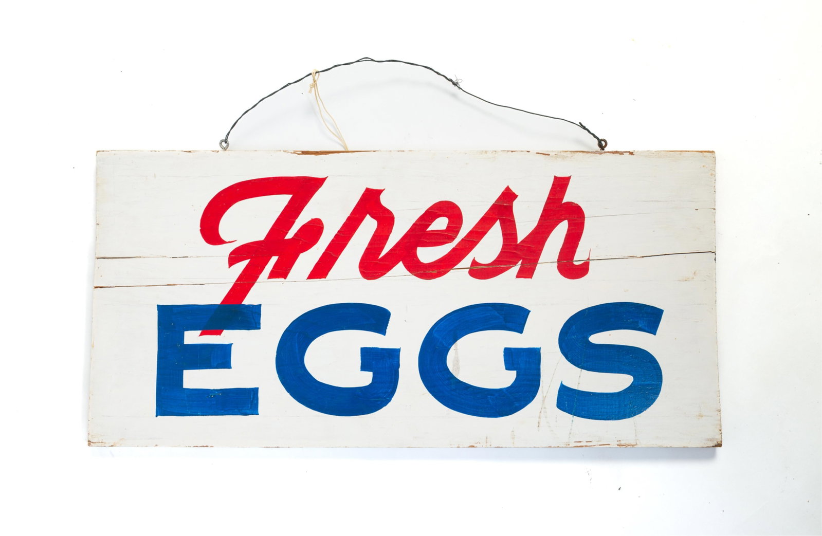 DOUBLE-SIDED FRESH EGGS WOODEN TRADE SIGN.: DOUBLE-SIDED FRESH EGGS WOODEN TRADE SIGN. American, 20th Century. Rectangular form, painted in blue and red letter on white ground, with wire on top for hanging. 11.5"h. 23.75"w.