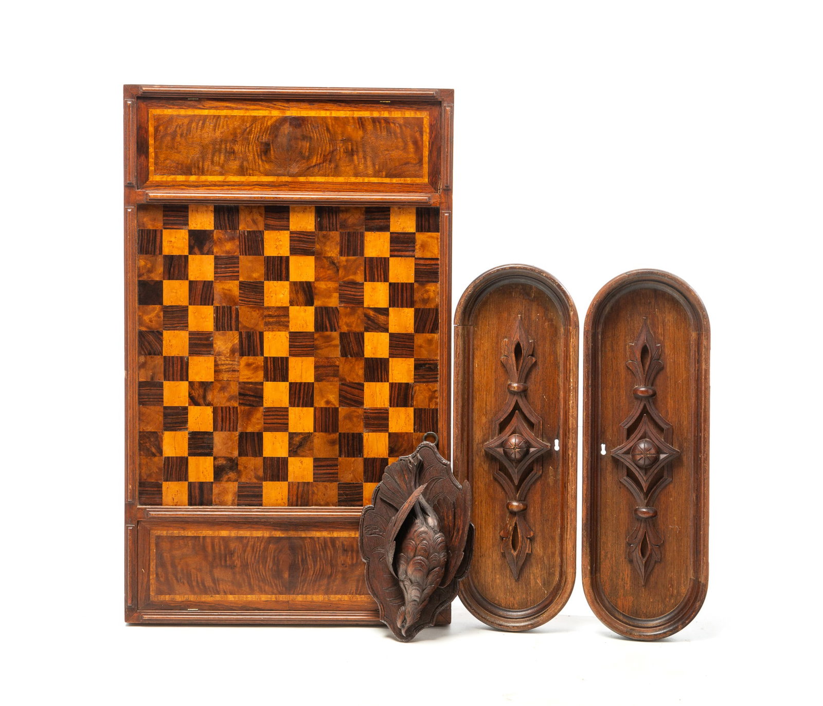 WOODEN GAMEBOARD, TWO CARVED PANELS, AND A GAMEBIRD WALL HANGING.: WOODEN GAMEBOARD, TWO CARVED PANELS, AND A GAMEBIRD WALL HANGING. American, Early 20th Century. A parquetry gameboard in different woods, hinged reserves at either end, and applied edge trim, two