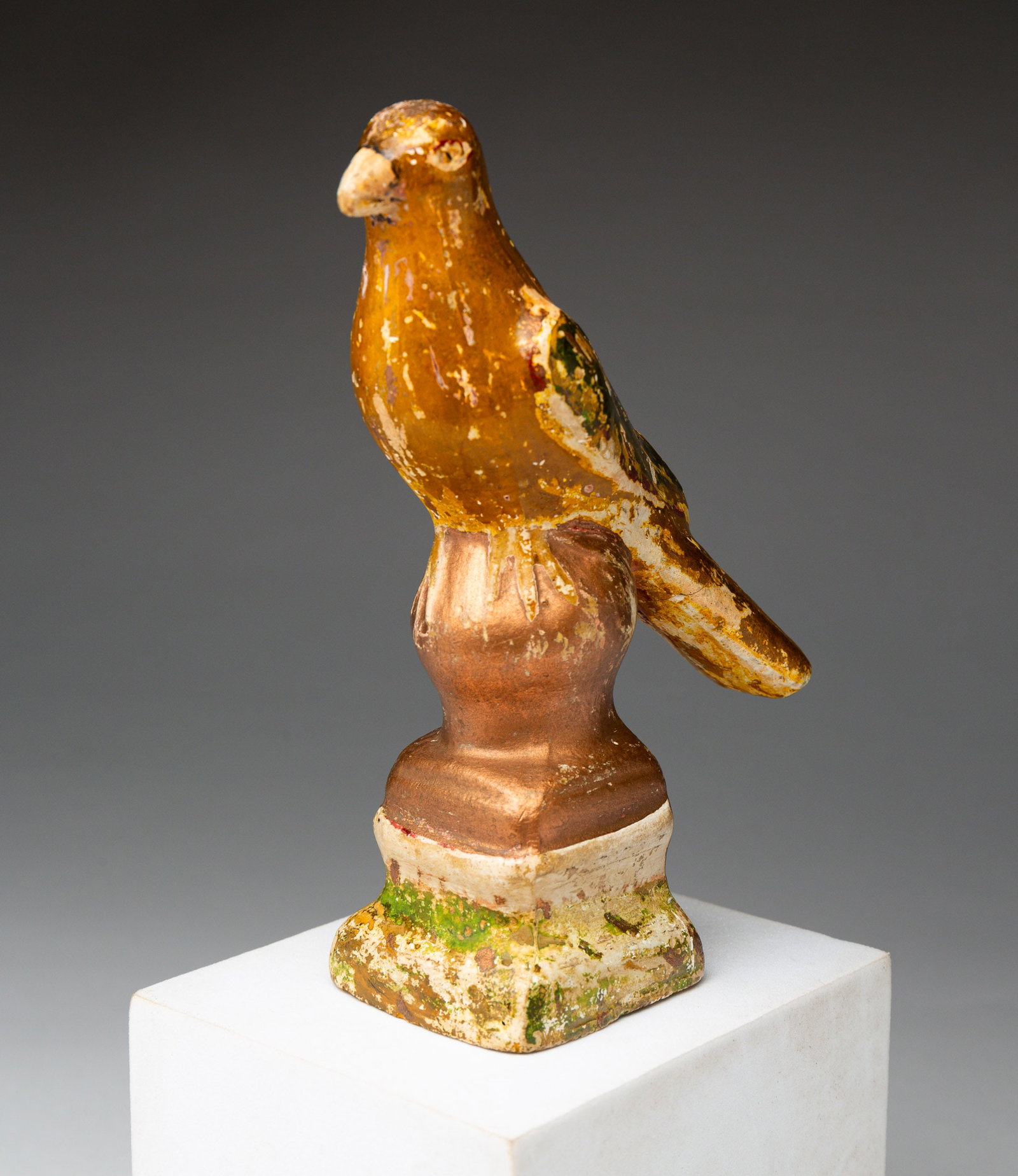 CHALKWARE BIRD ON PLINTH.: CHALKWARE BIRD ON PLINTH. American, second half 19th Century. Colorful paint has some wear and bronze center section of plinth is a repaint. 6"h.