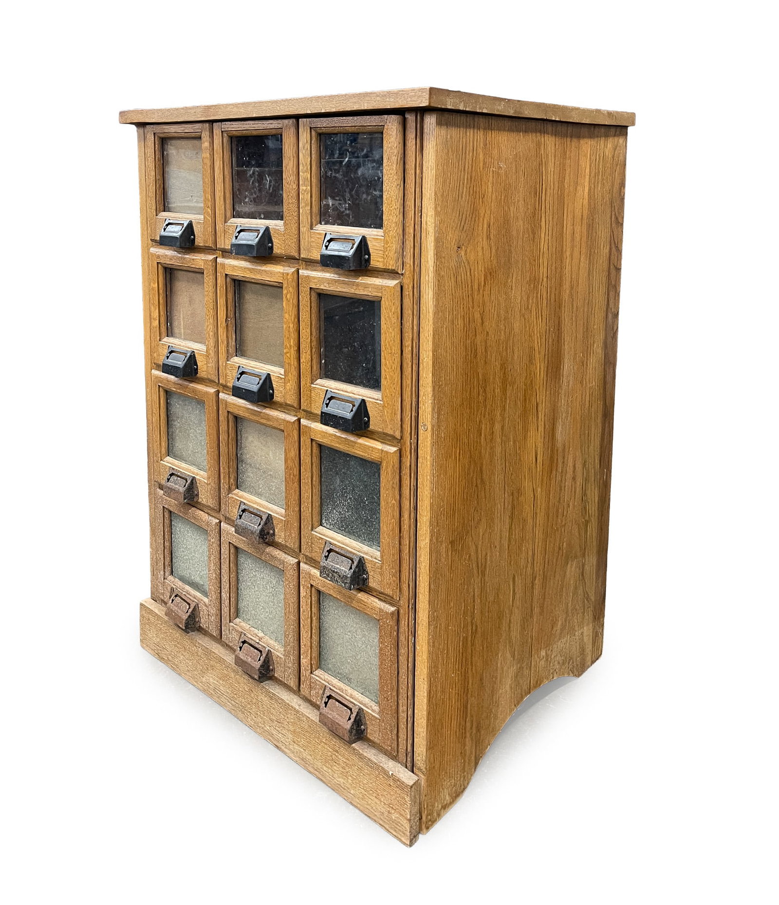 TWELVE-DRAWER SEED BIN.: TWELVE-DRAWER SEED BIN. American, Late 19th or Early 20th Century. Wood. Two-board top, twelve drawers with viewing windows and cast iron pulls. Simple base molding and arched cut-out ends. 36"h.