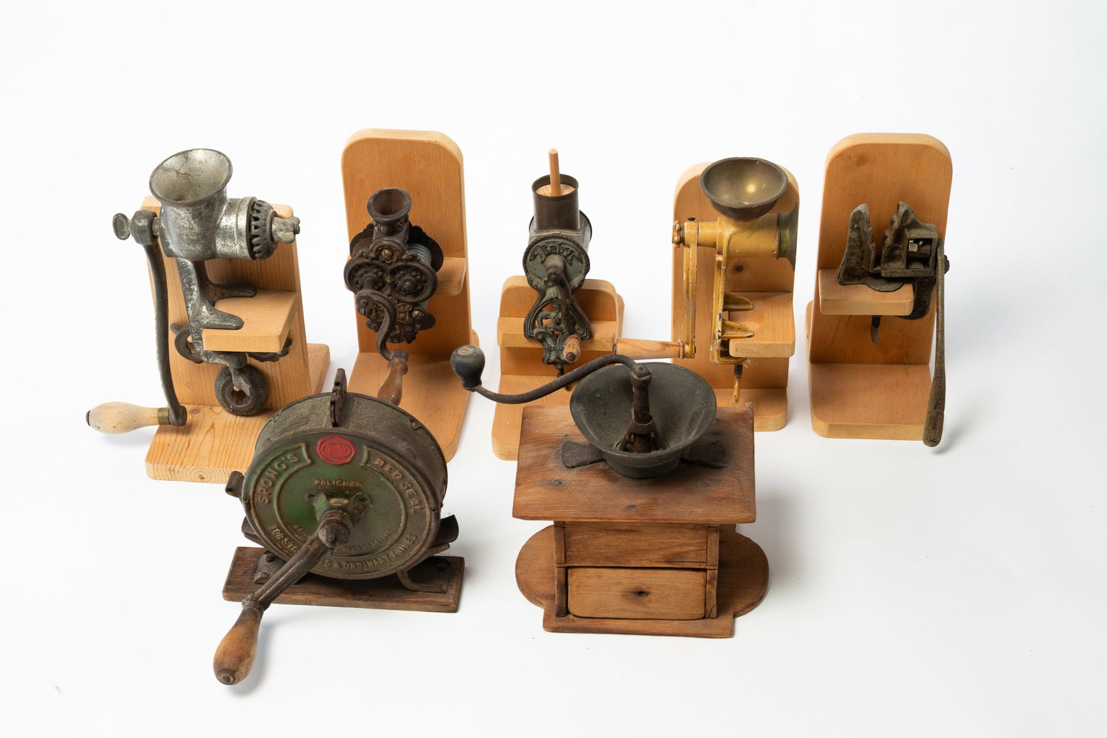 SEVEN METAL KITCHEN GADGETS INCL. KNIFE SHARPENER.: SEVEN METAL KITCHEN GADGETS INCL. KNIFE SHARPENER. American and German, Late 19th or Early 20th Century. Metal and wood. Comprising grinders, a knife sharpener, and a nutcracker. Mounted on various
