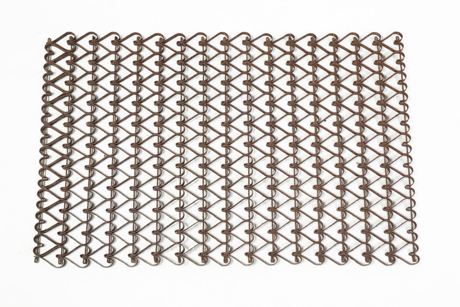 WROUGHT IRON HEART MAT.: WROUGHT IRON HEART MAT. American, Late 19th Century. Linked wrought iron hearts forming a rectangular mat. 16"h. 24"w. Provenance: From the Lifetime Collection of Marilyn and the late Jack Reinhardt