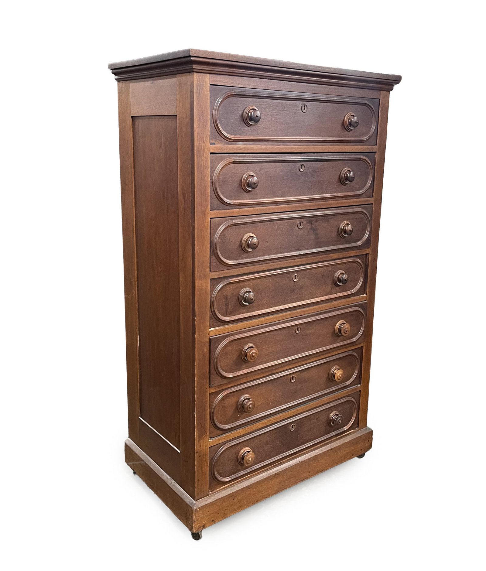 VICTORIAN WALNUT SEVEN-DRAWER CHEST.: VICTORIAN WALNUT SEVEN-DRAWER CHEST. American, Late 19th Century. Having a rectangular, molded top above paneled sides and a stack of seven drawers. It rises on a molded base with casters, 62.5"h. 36.