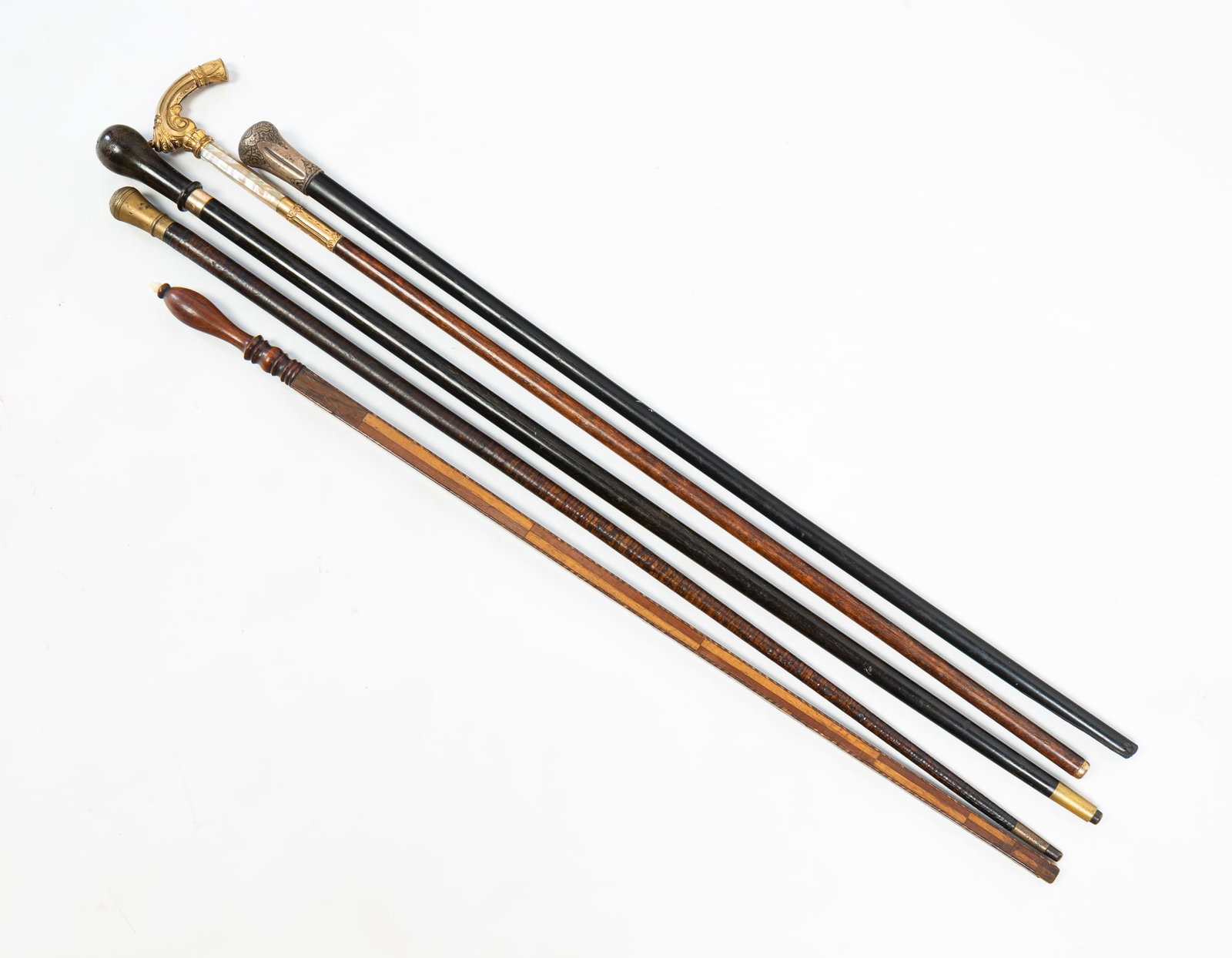 GROUPING OF MEN'S ACCESSORIES.: GROUPING OF MEN'S ACCESSORIES. American, 19th Century. Including three walking sticks with tapered forms and knob tops, a cane with a mother-of-pearl ferrule, and gold-filled handle, together with a p
