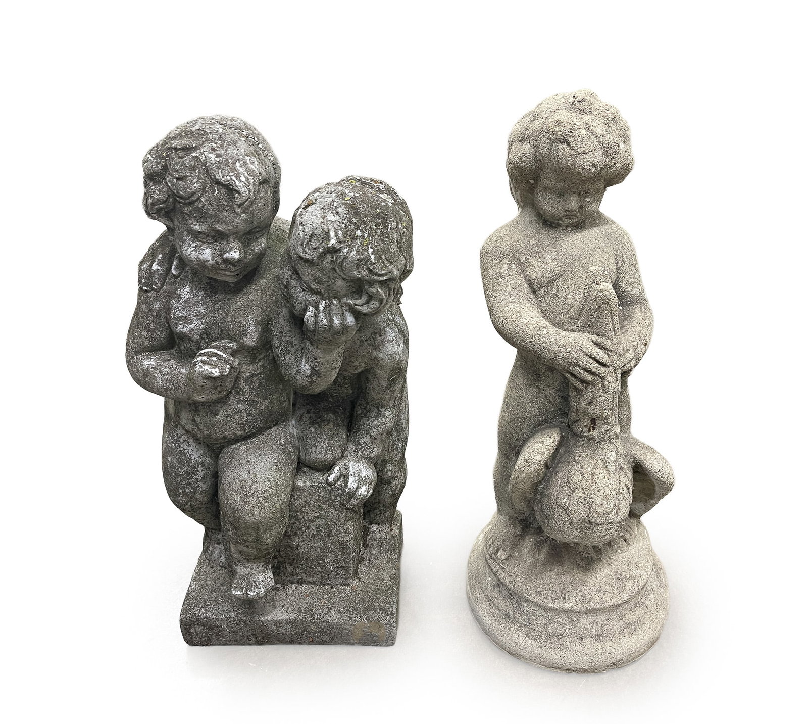 TWO CONCRETE GARDEN STATUES.: TWO CONCRETE GARDEN STATUES. American, 20th Century. Two putti seated on a rectangular plinth, 19.5"h., and a putto with a duck, 19.5"h. Provenance: The Lifetime Collection of Martha Magsig Lynch
