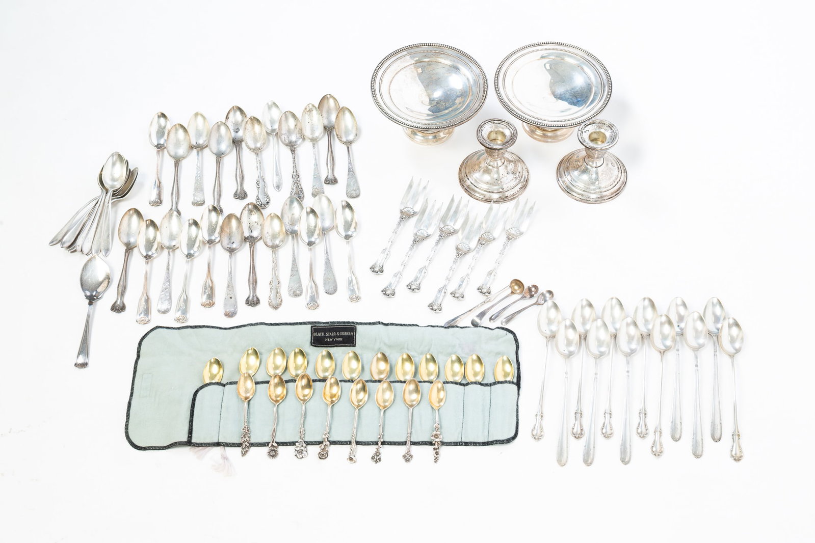 GROUP OF ASSORTED STERLING SILVER FLATWARE AND WEIGHTED TABLE ACCESSORIES.: GROUP OF ASSORTED STERLING SILVER FLATWARE AND WEIGHTED TABLE ACCESSORIES. American, 20th Century. Includes a set of Reed and Barton floral handled demitasse spoons, six International iced tea