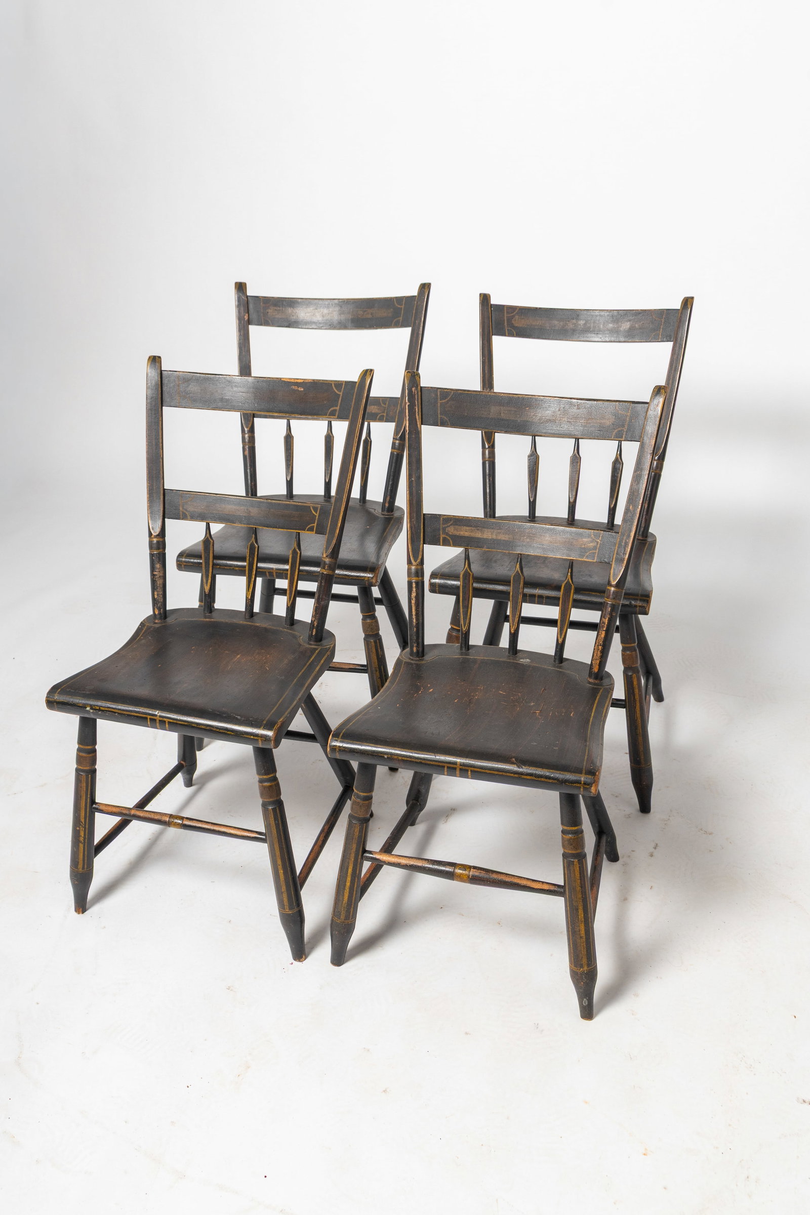 FOUR PENNSYLVANIA HALF-ARROWBACK SIDE CHAIRS WITH ORIGINAL PAINT DECORATION.: FOUR PENNSYLVANIA HALF-ARROWBACK SIDE CHAIRS WITH ORIGINAL PAINT DECORATION. American, 19th Century. Mixed woods. Each having a tablet crest flanked by thumbback stiles continuing to three half arrow 